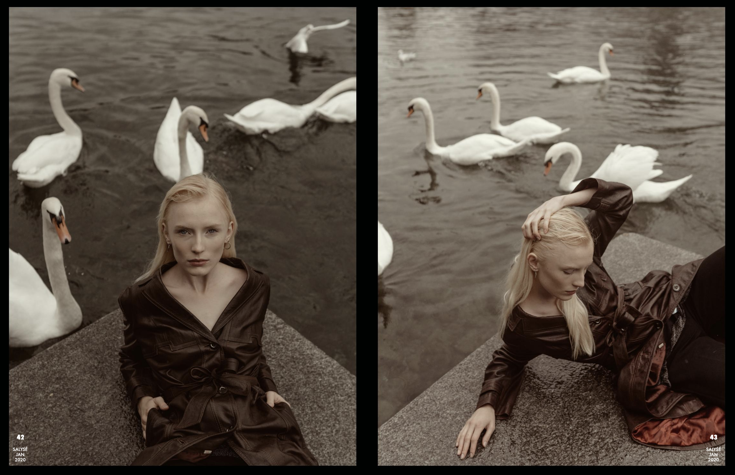 A young woman with long blonde hair sitting on a stone ledge by the water, wearing a brown leather jacket. Swans swim in the water behind her, and she is in a reflective pose with her hand in her hair. The photo is split into two halves, with slight 