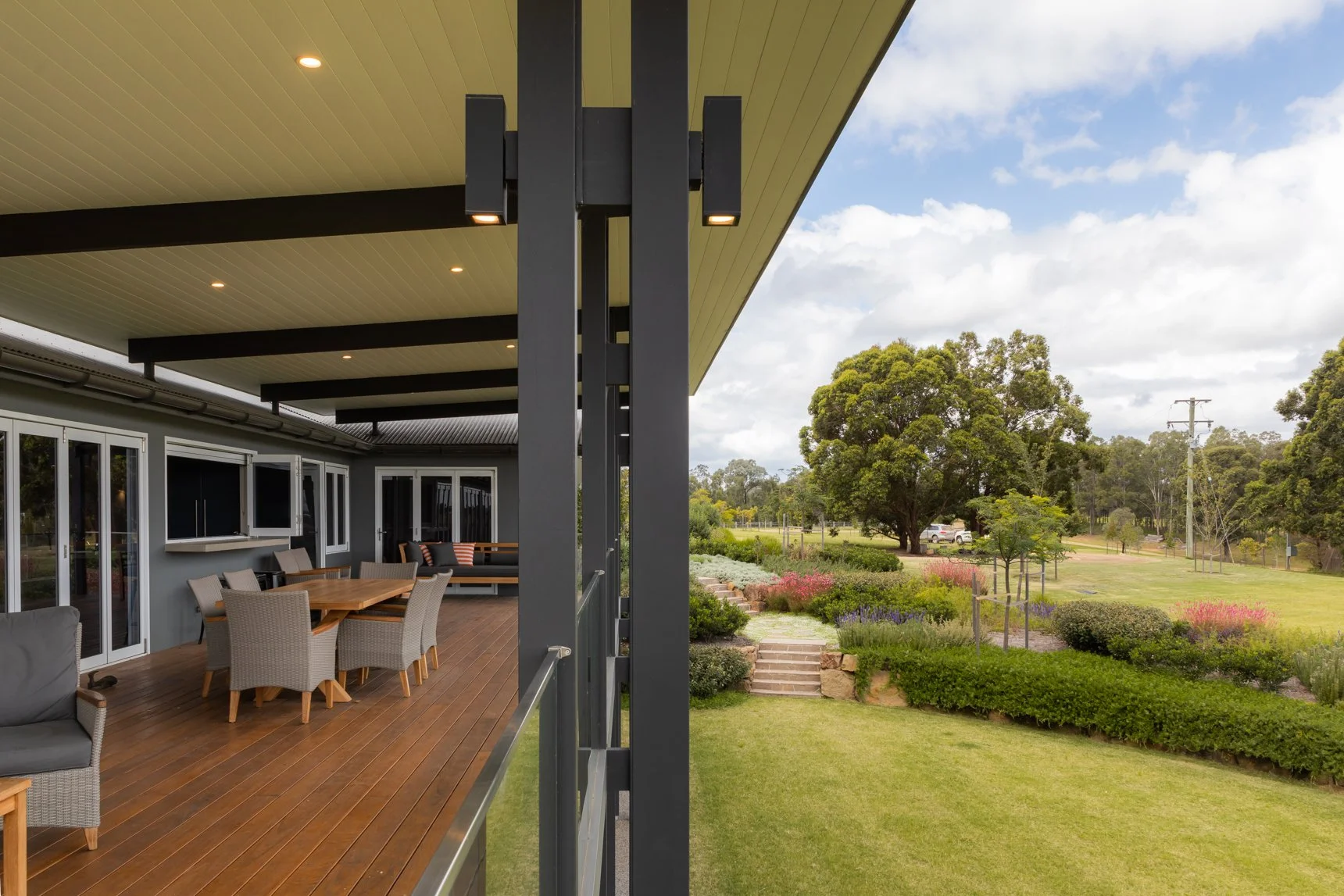 Custom houses Newcastle balcony with garden and outdoor seating.
