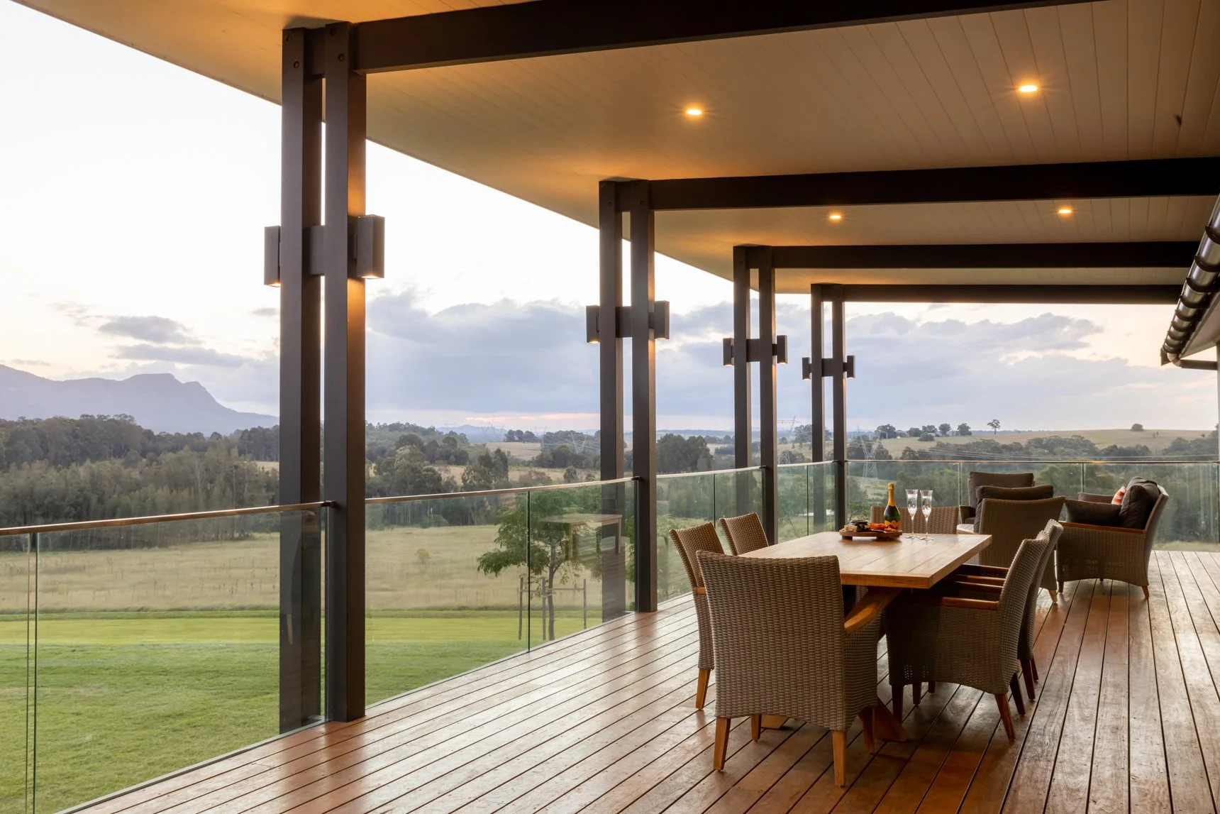 Custom houses Newcastle balcony with dining and mountain views.