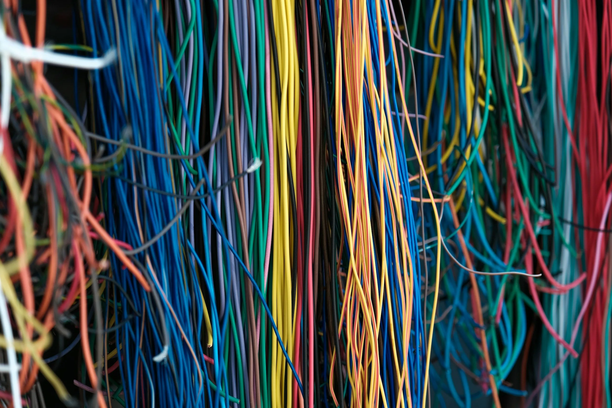 A large collection of multicolored wires tangled together.
