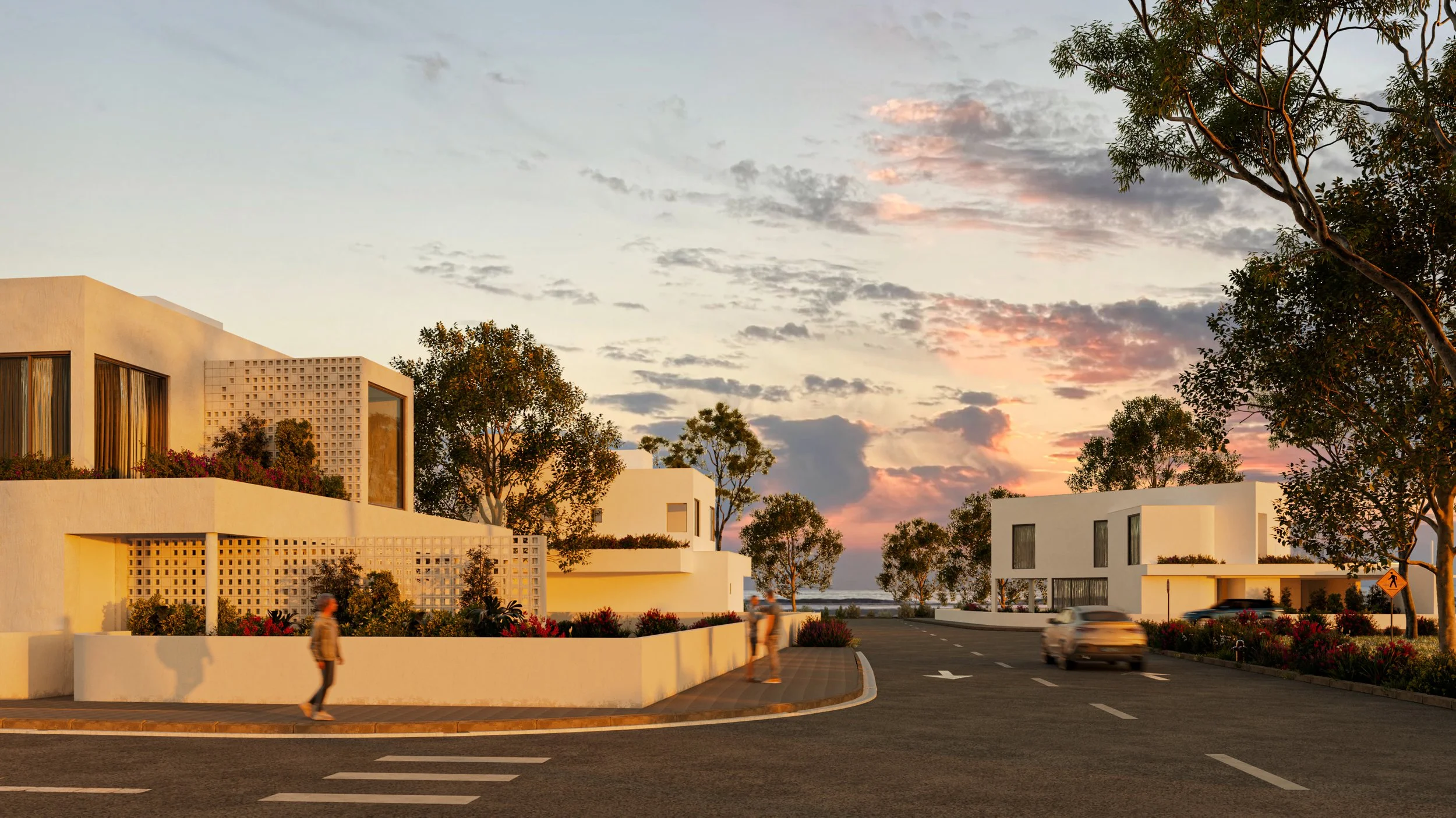 Modern white residential buildings with large windows and flat roofs, surrounded by trees and colorful flowers, at sunset. Cars driving on the curved street and people walking are visible, with a mediterranean seaside view. Beach luxury villa getaway