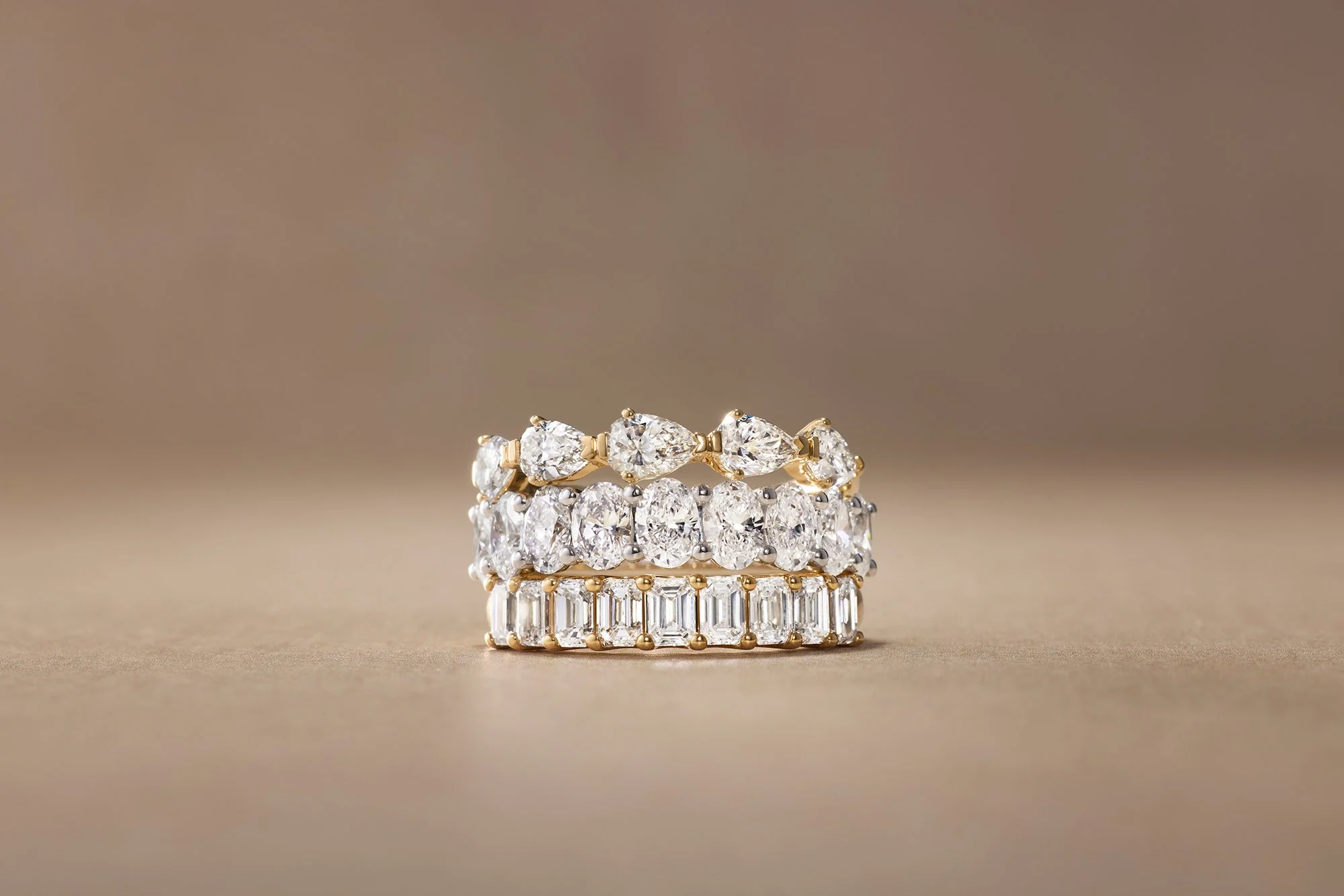 Stacked rings with large diamonds and baguette-cut diamonds.
