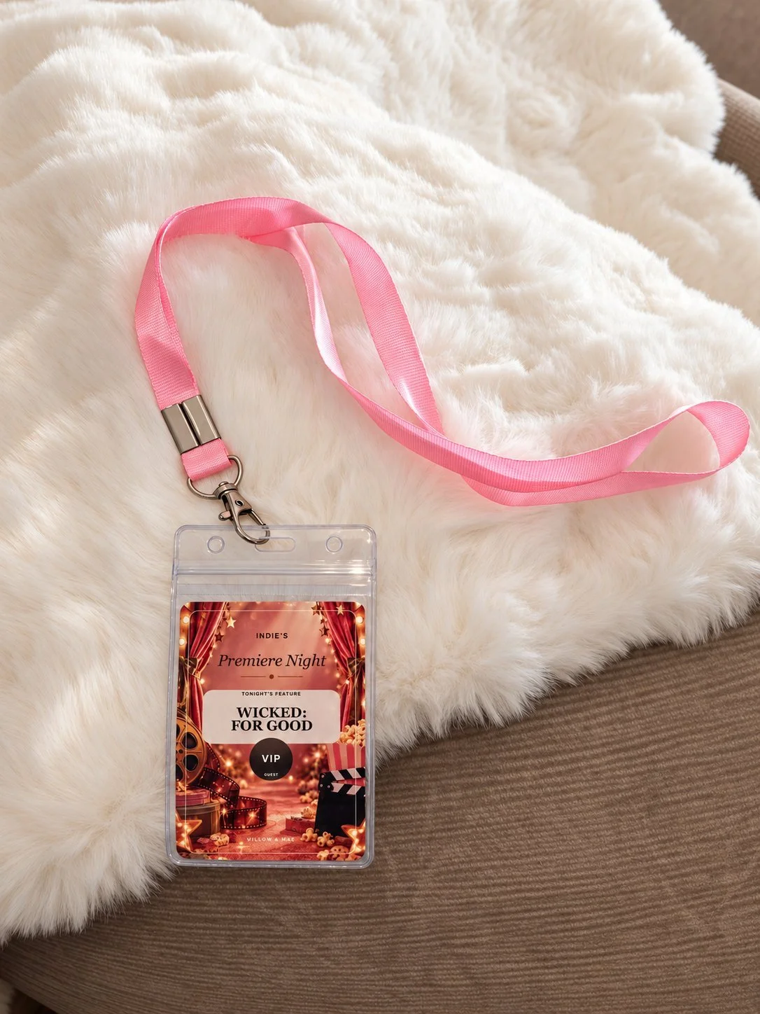 Personalised VIP lanyard pass for a Premiere Night movie party resting on a faux fur throw