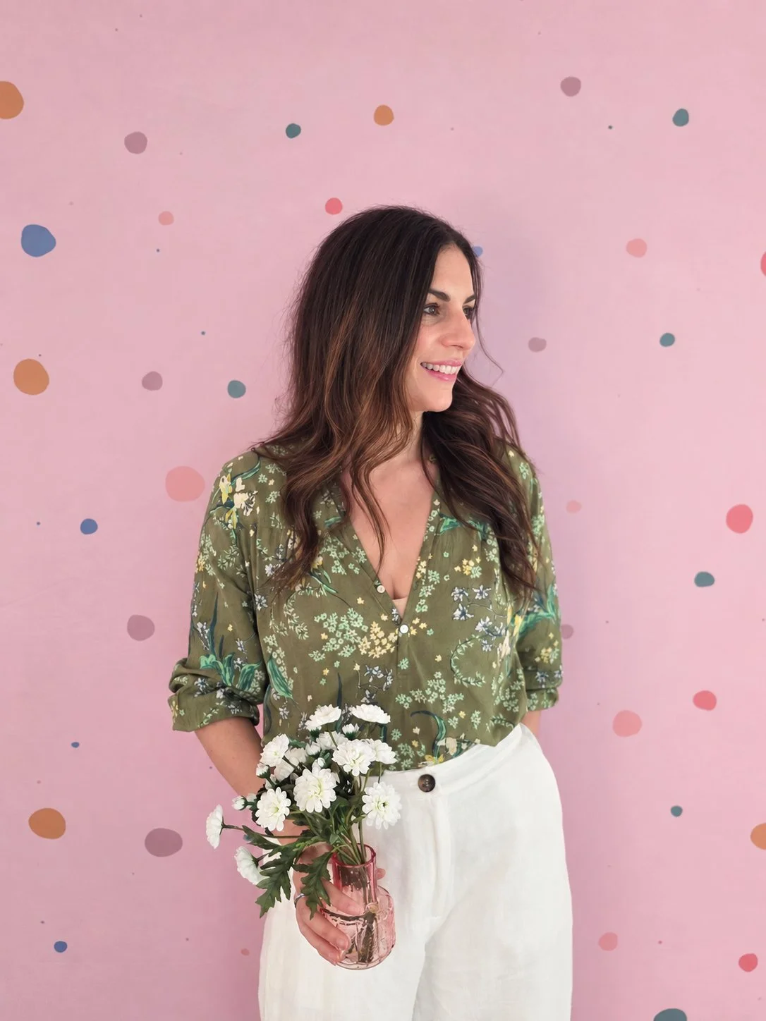 Kristy, founder of Willow & Mae children's parties in Melbourne, holding a posy of white flowers