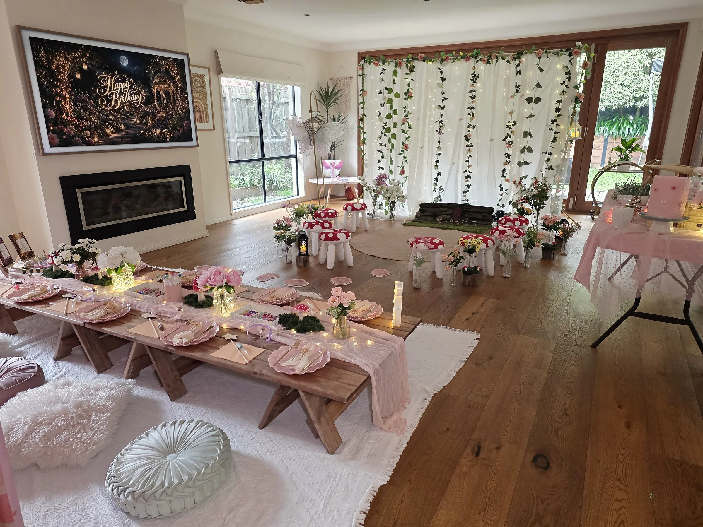Enchanted Garden party room with a banquet table, toadstool stools and a hanging vine backdrop