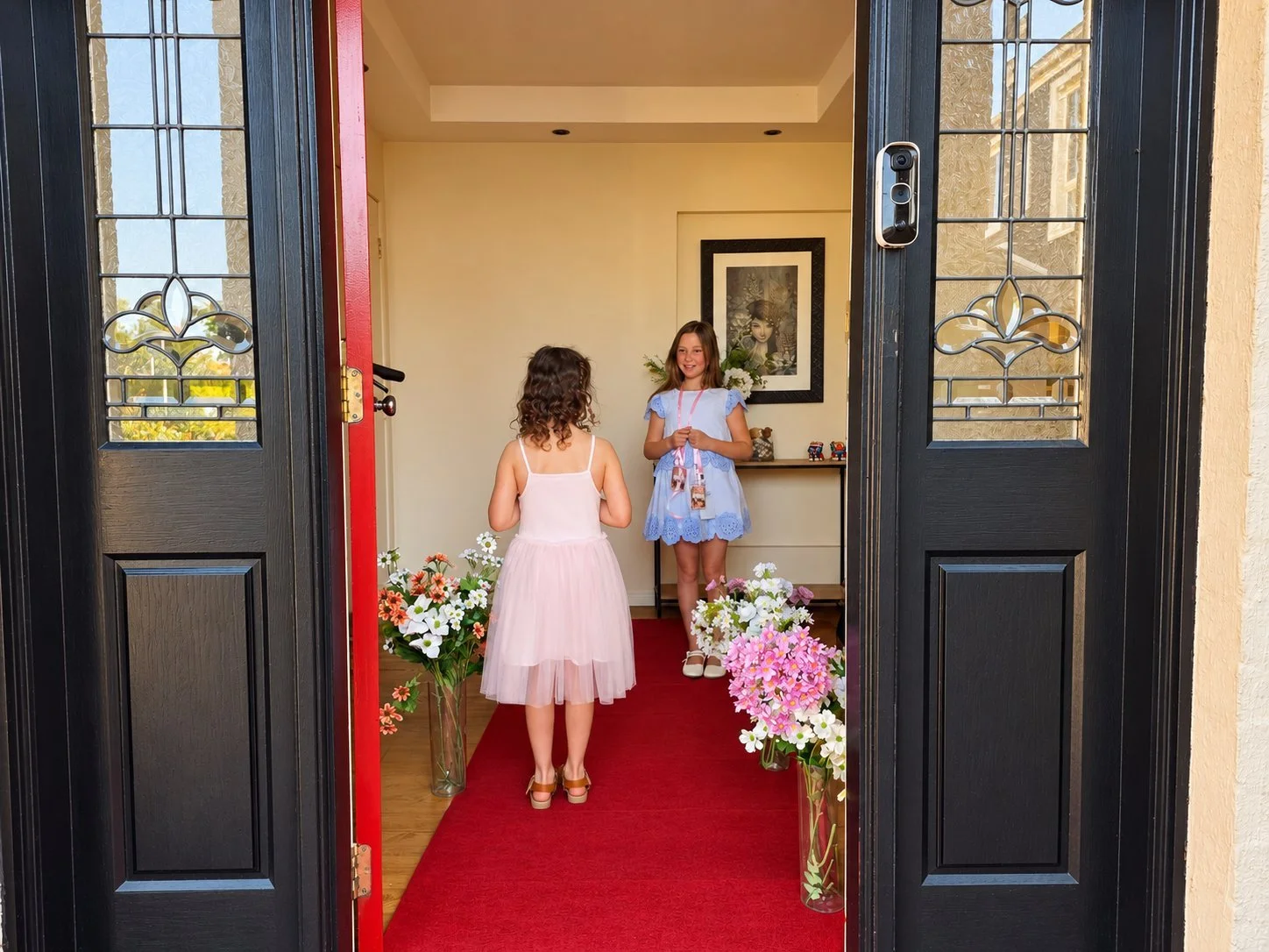 Guests arriving along a flower-lined red carpet at a Premiere Night party