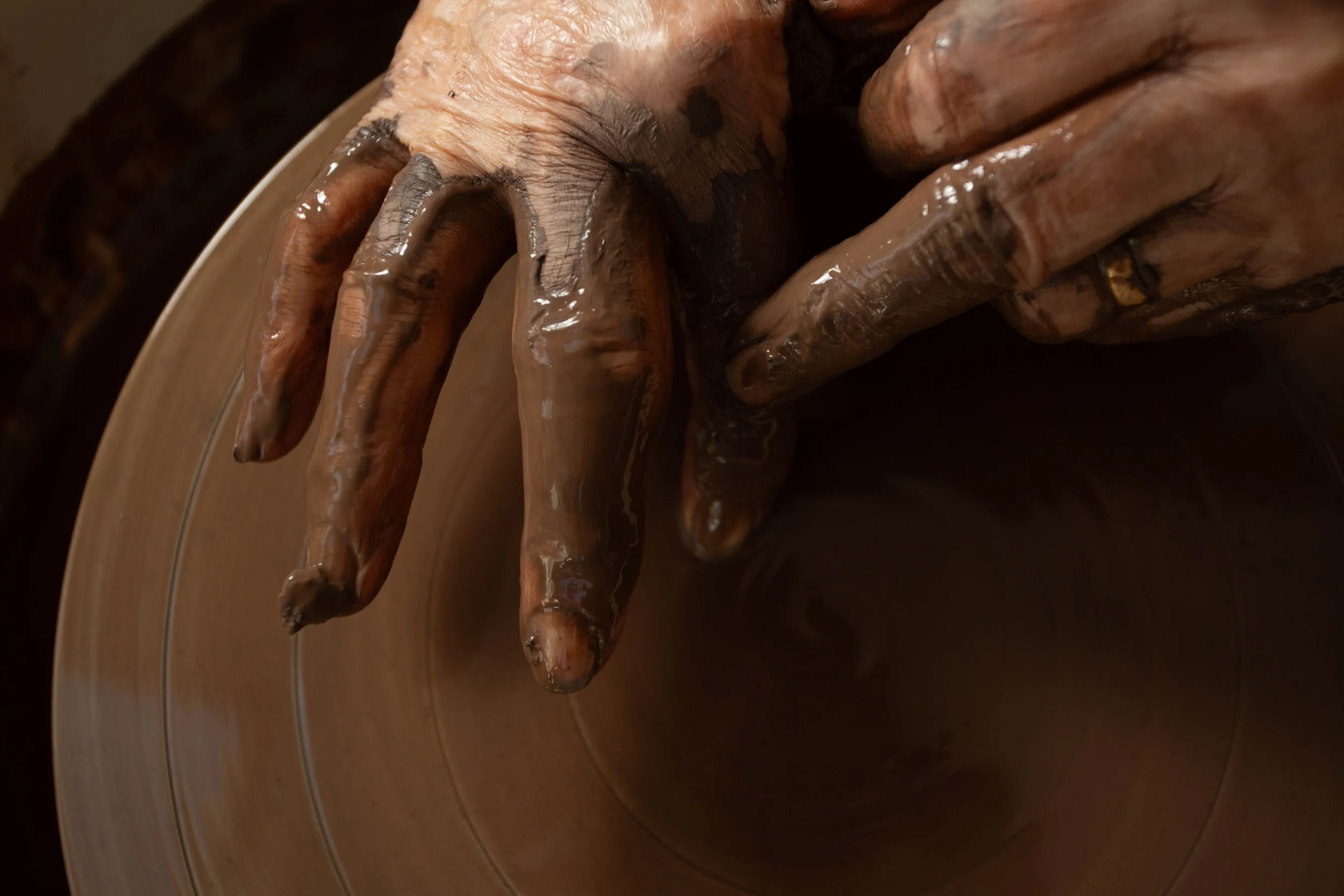 Hands preparing clay for a pottery throwing lesson in Bishopstoke