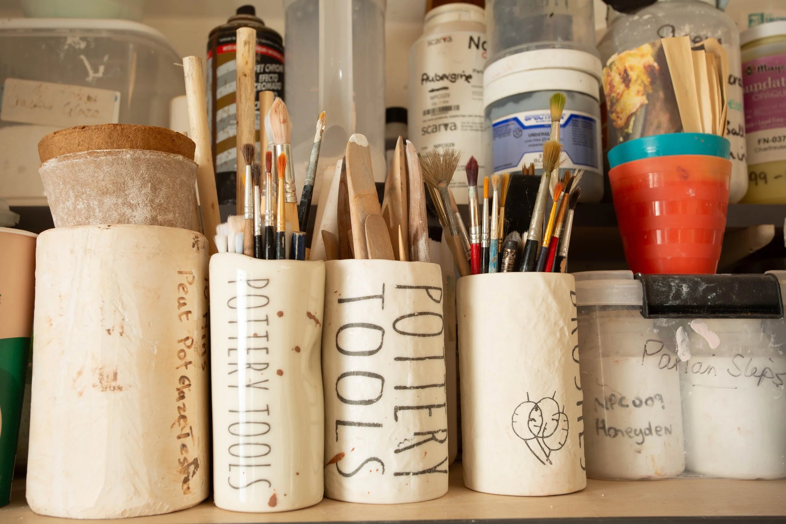 pots in ceramic sudio holding tools