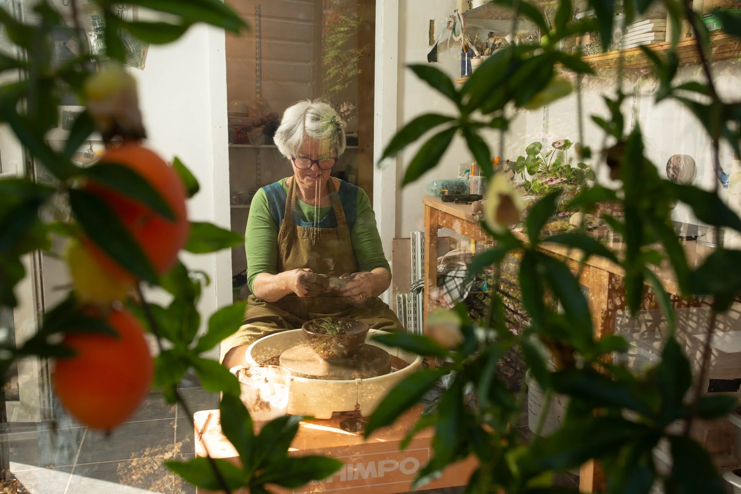 Sheena at her potters wheel in her garden ceramics studio