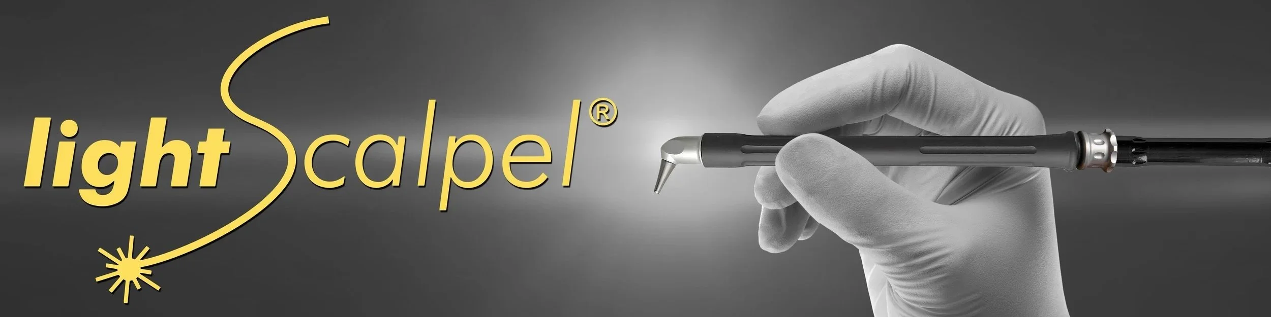 A gloved hand holding a dental curing light aimed at the text 'light cure'.