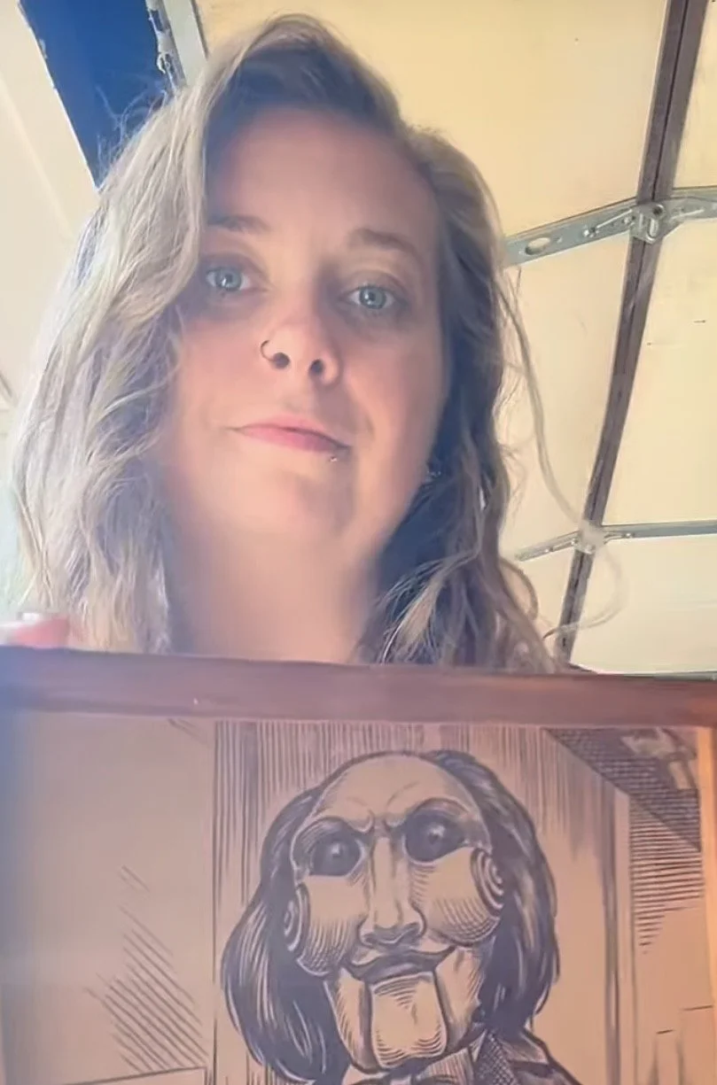 Artist with custom laser engraved wood artwork featuring Billy the Puppet from the Saw movies.