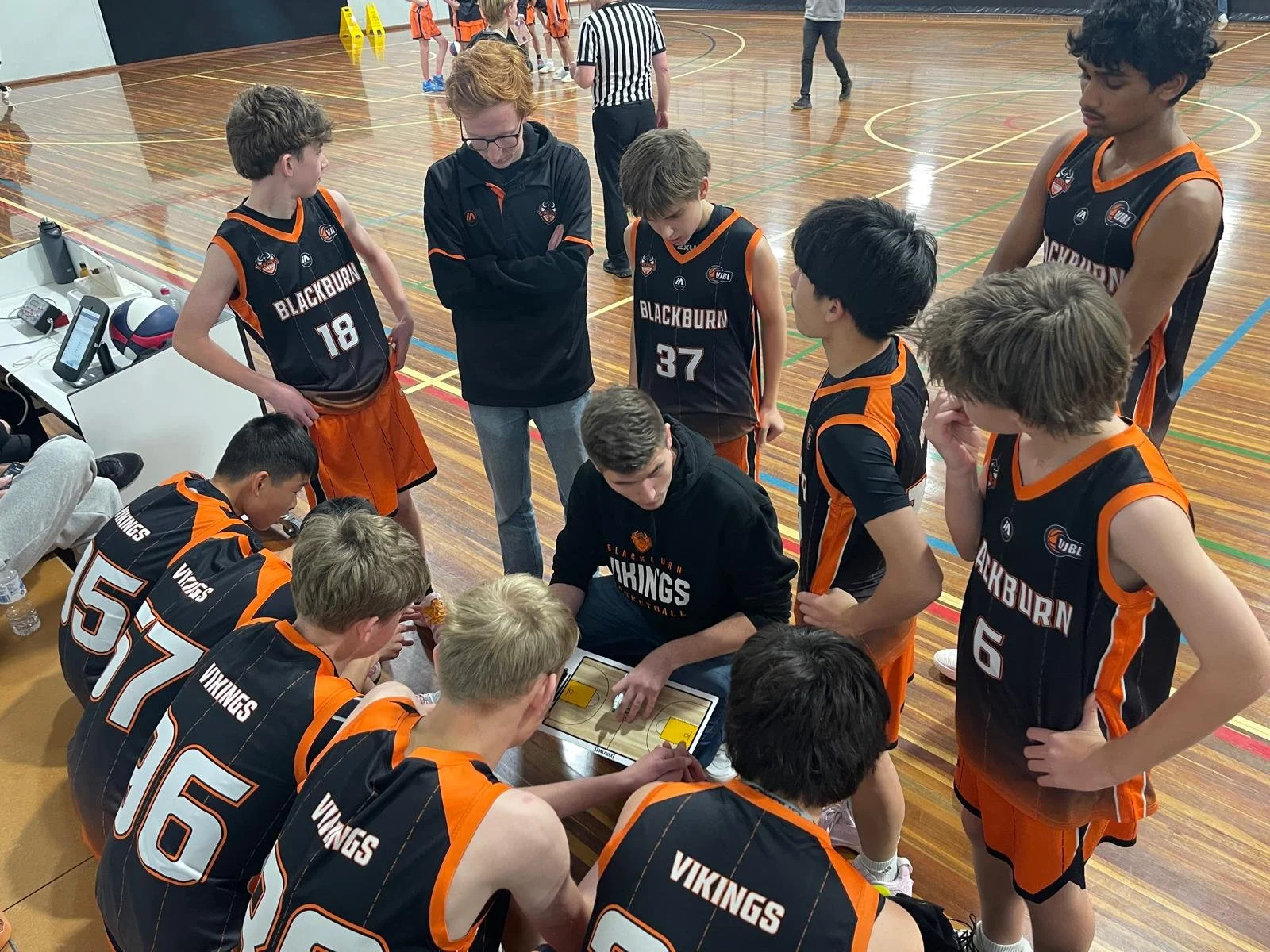 VJBL 2026 Under 16 Boys team listening to a coach during a timeout