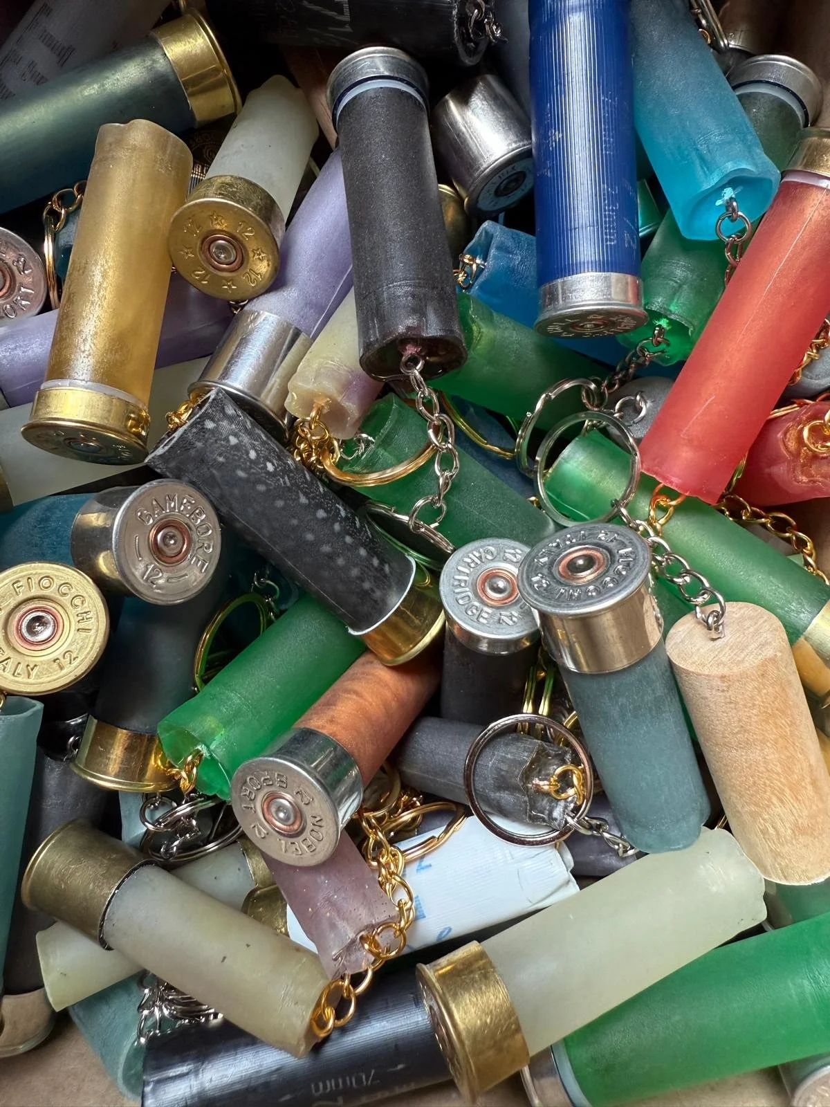 A pile of colorful, used shotgun shells with attached chains.