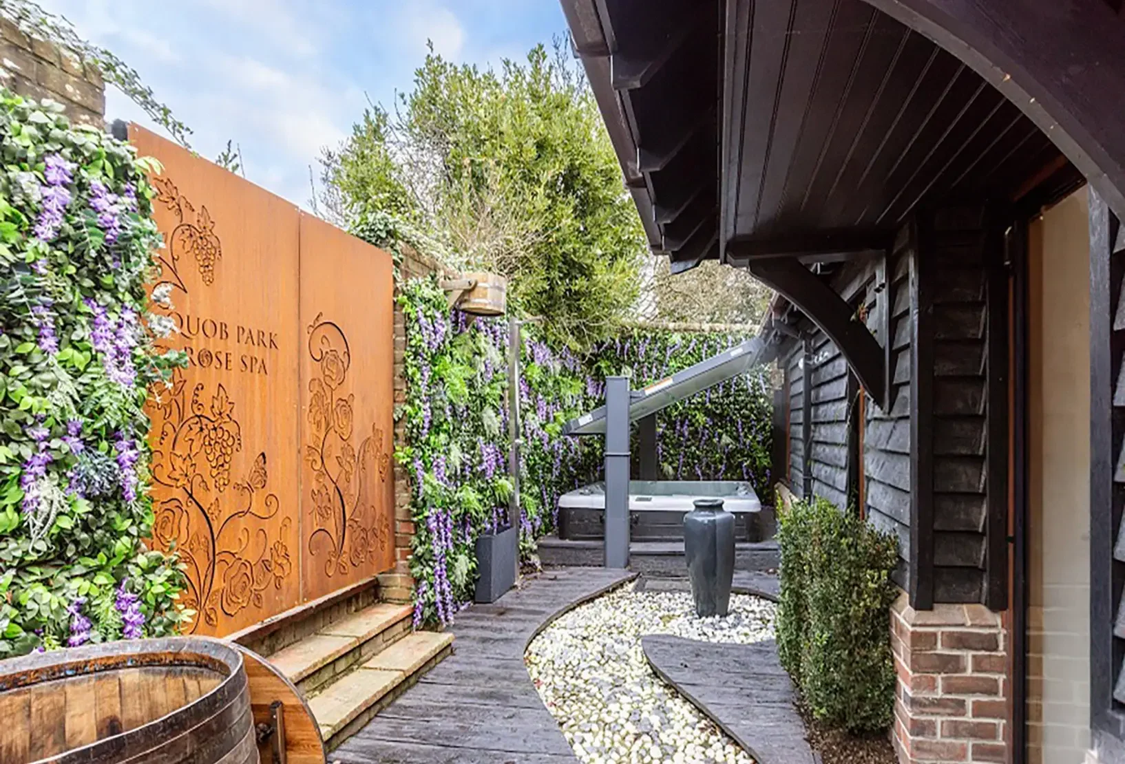 Rose Spa Garden with bespoke laser-cut Corten panels, Jacuzzi pool and ice-cold deluge bucket shower