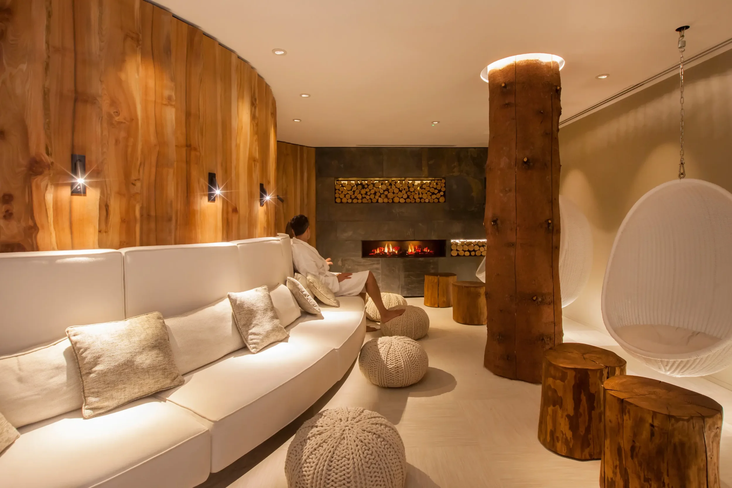 Spa relaxation suite at Champneys Forest Mere, featuring curved seating, natural timber finishes and soft ambient lighting.