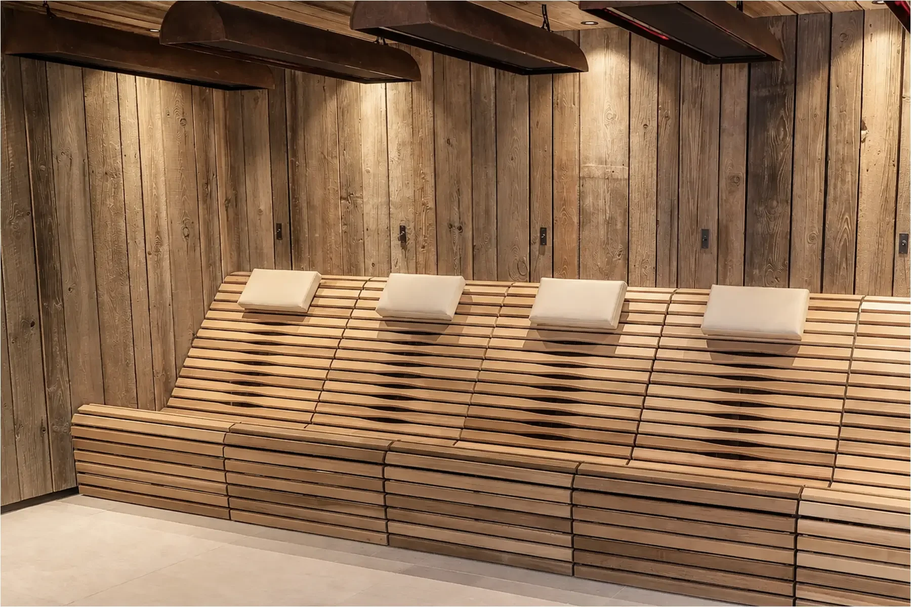 Bespoke infrared therapy bench with integrated infrared lamps at Homefield Grange, set within a rustic timber-clad treatment room.