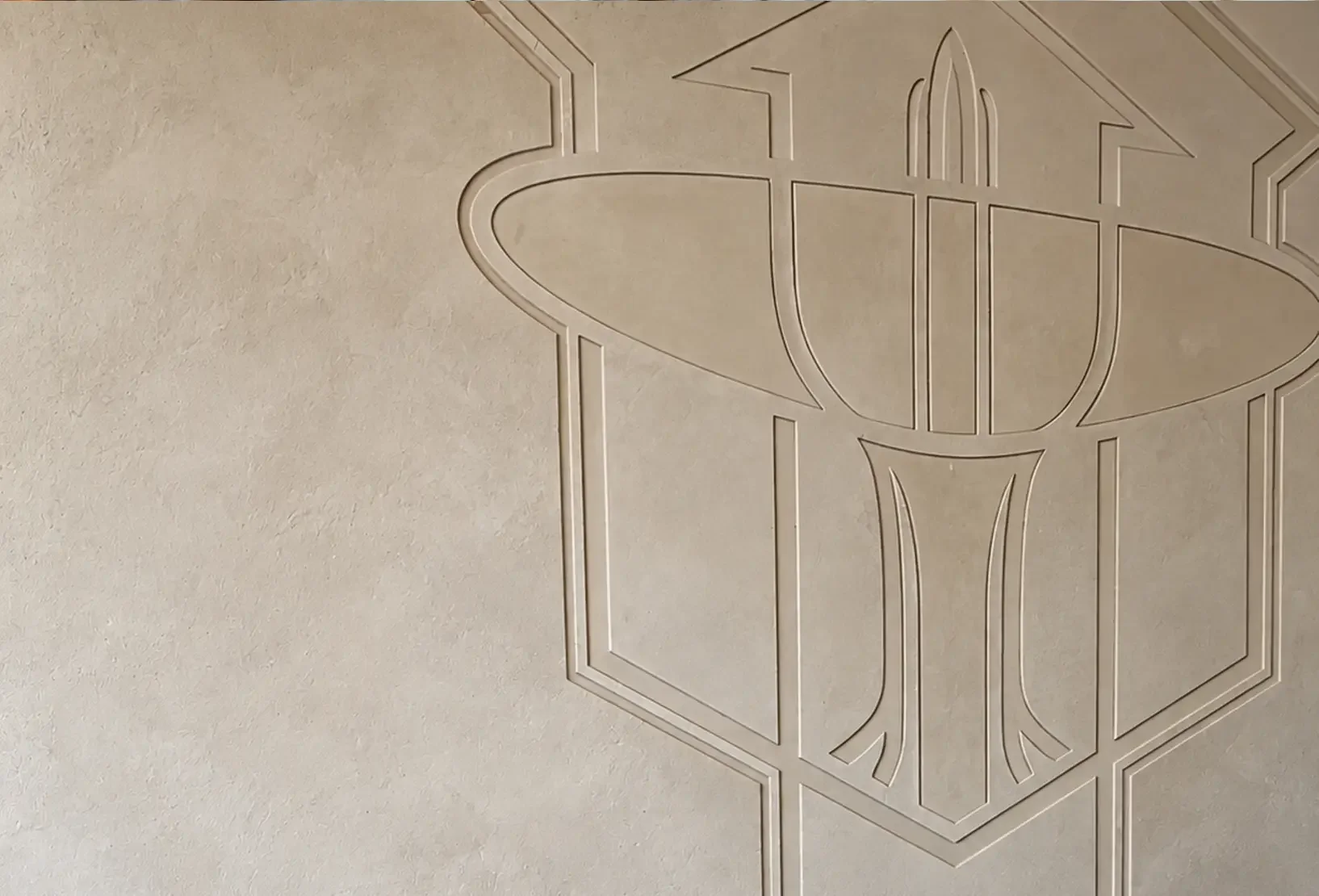 Silverlake Spa logo subtly embossed into the plaster wall within the reception area.