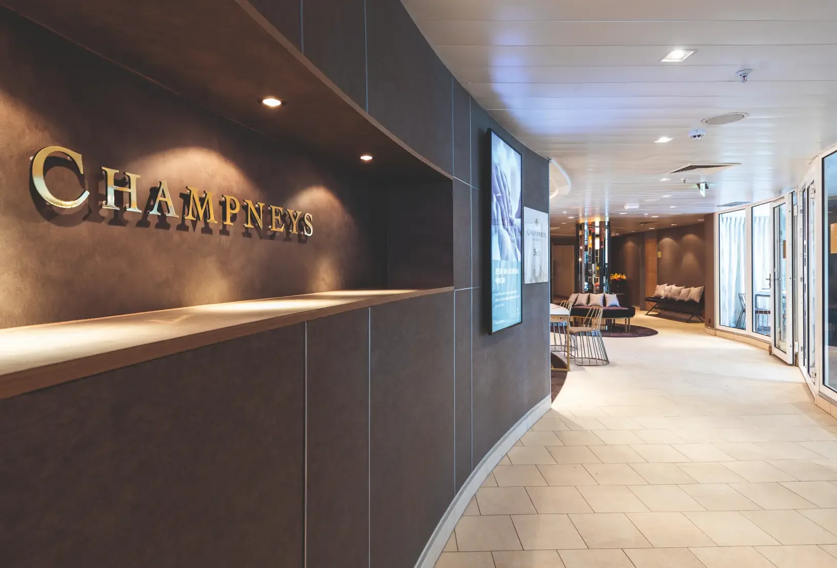 Spa corridor leading to the waiting area with bespoke clad storage units and integrated lighting.