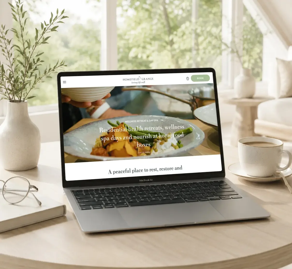 Homefield Grange wellness retreat website displayed on a laptop, featuring nature-inspired branding and digital design.