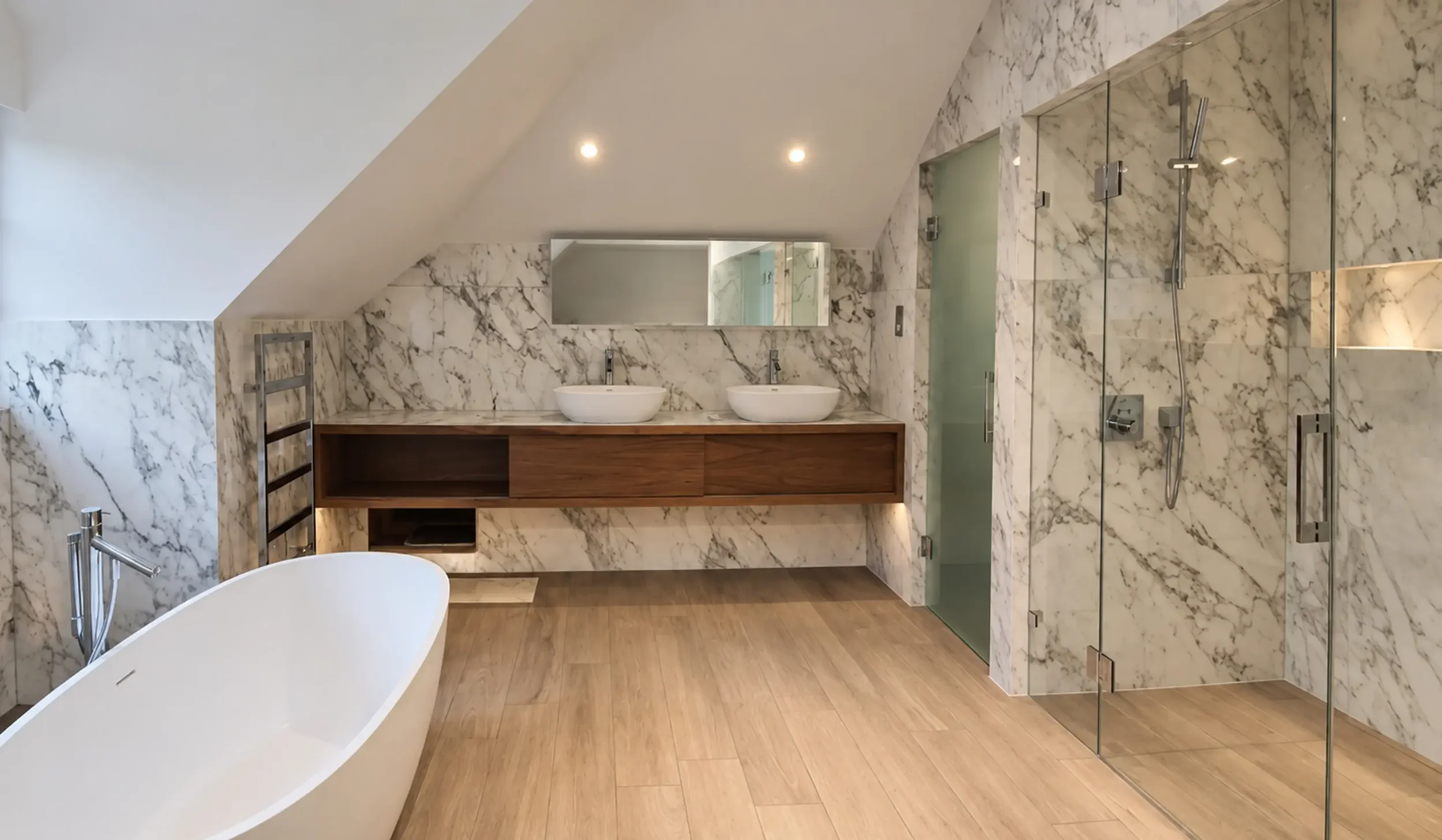 Luxury principal en suite bathroom featuring a freestanding bath, marble-effect walls, bespoke timber vanity, walk-in shower and contemporary brass fittings.