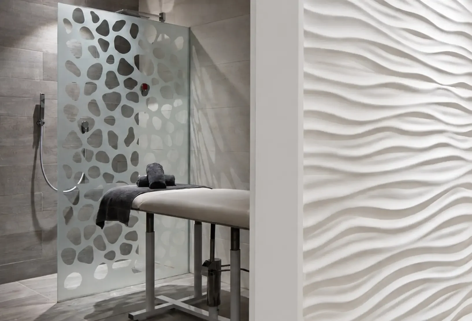 Treatment room and corridor with sculpted wave wall panelling at Champneys Tring