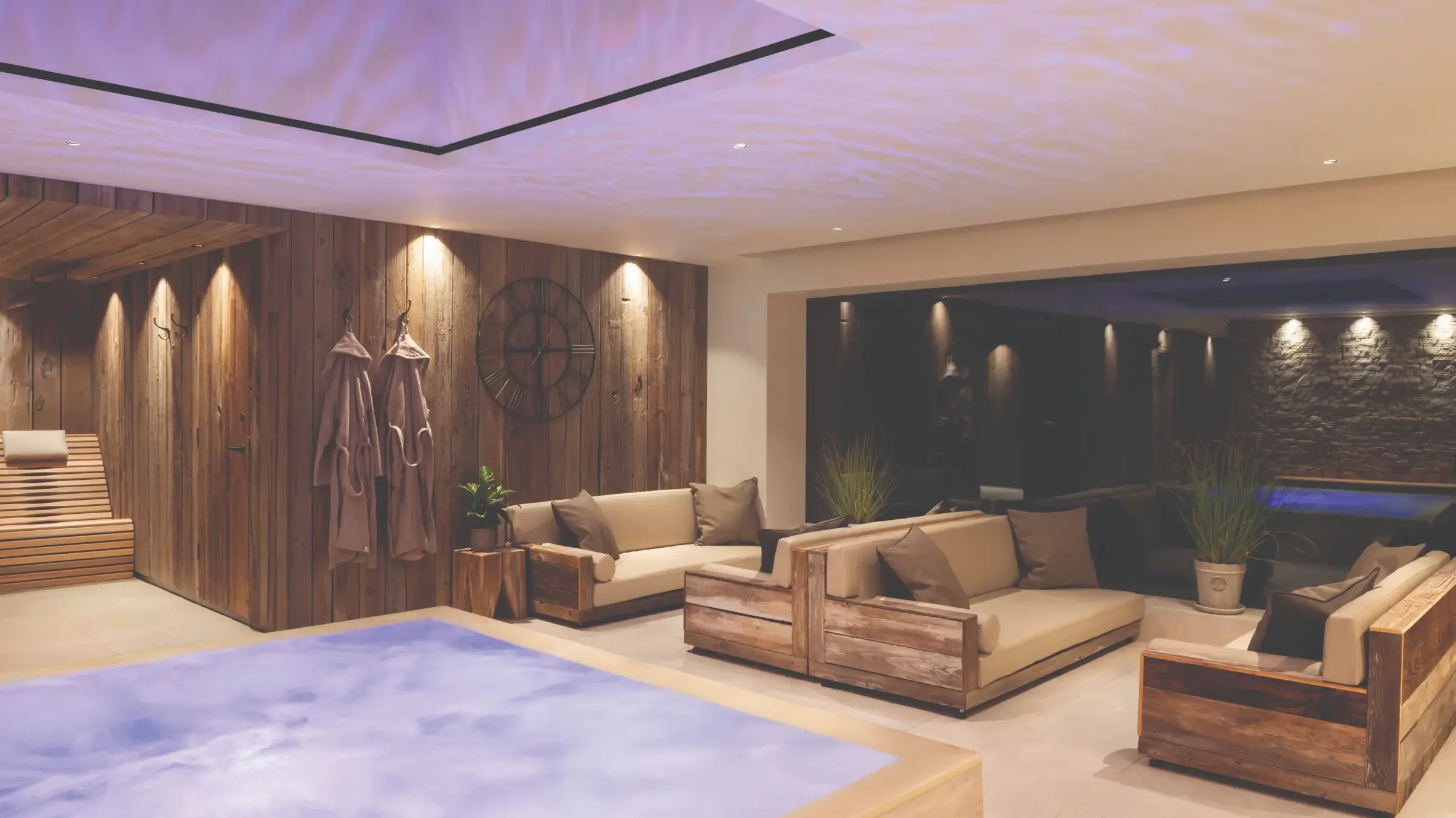 Hydrotherapy pool and magnetic relaxation loungers at Homefield Grange, with a bespoke infrared heated bench beyond.