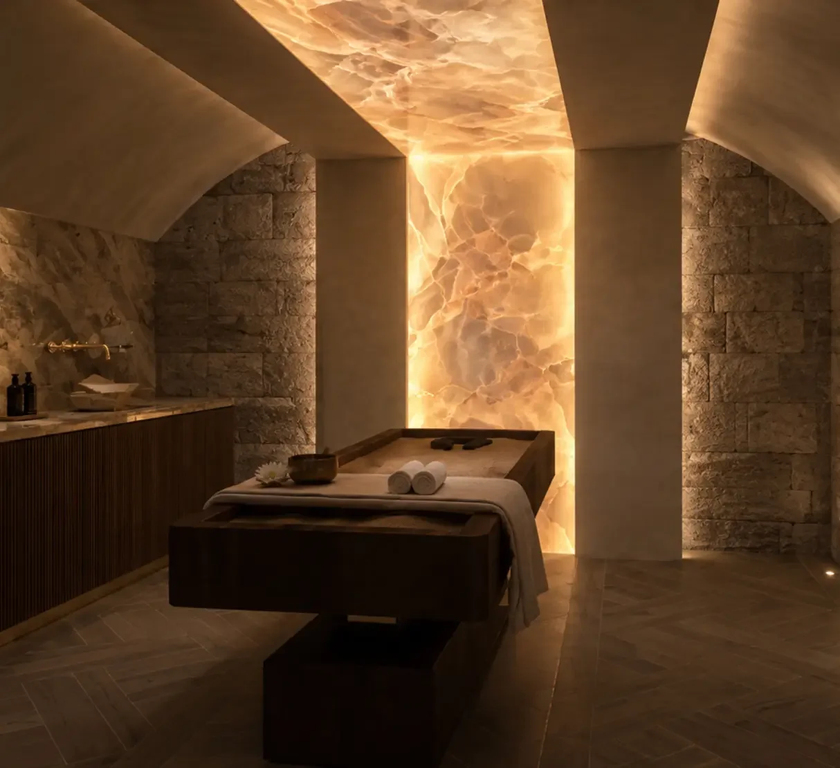 Quartz sand treatment room with backlit onyx and exposed original castle basement walls