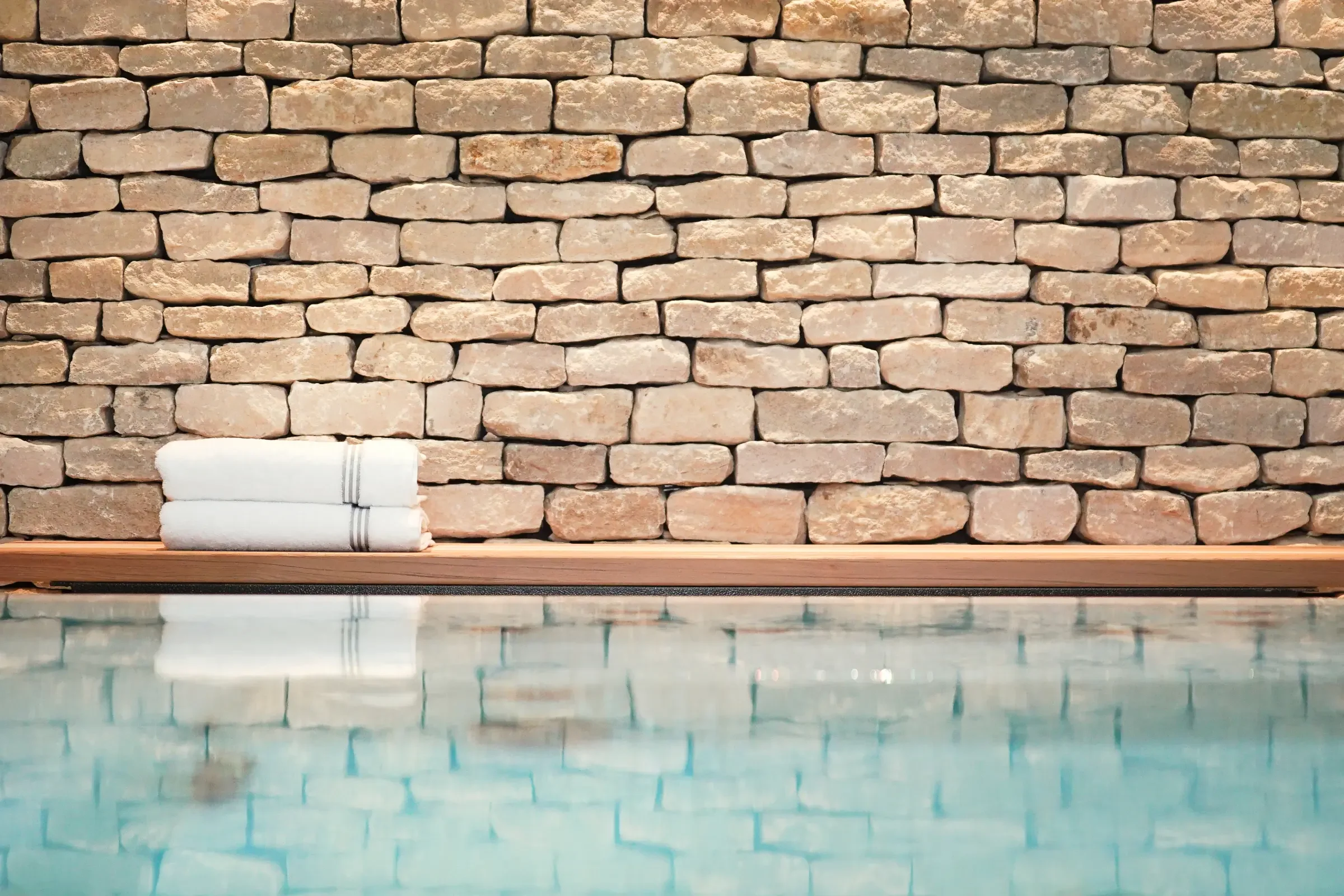 Homefield Grange hydrotherapy pool with natural rustic dry stone wall behind