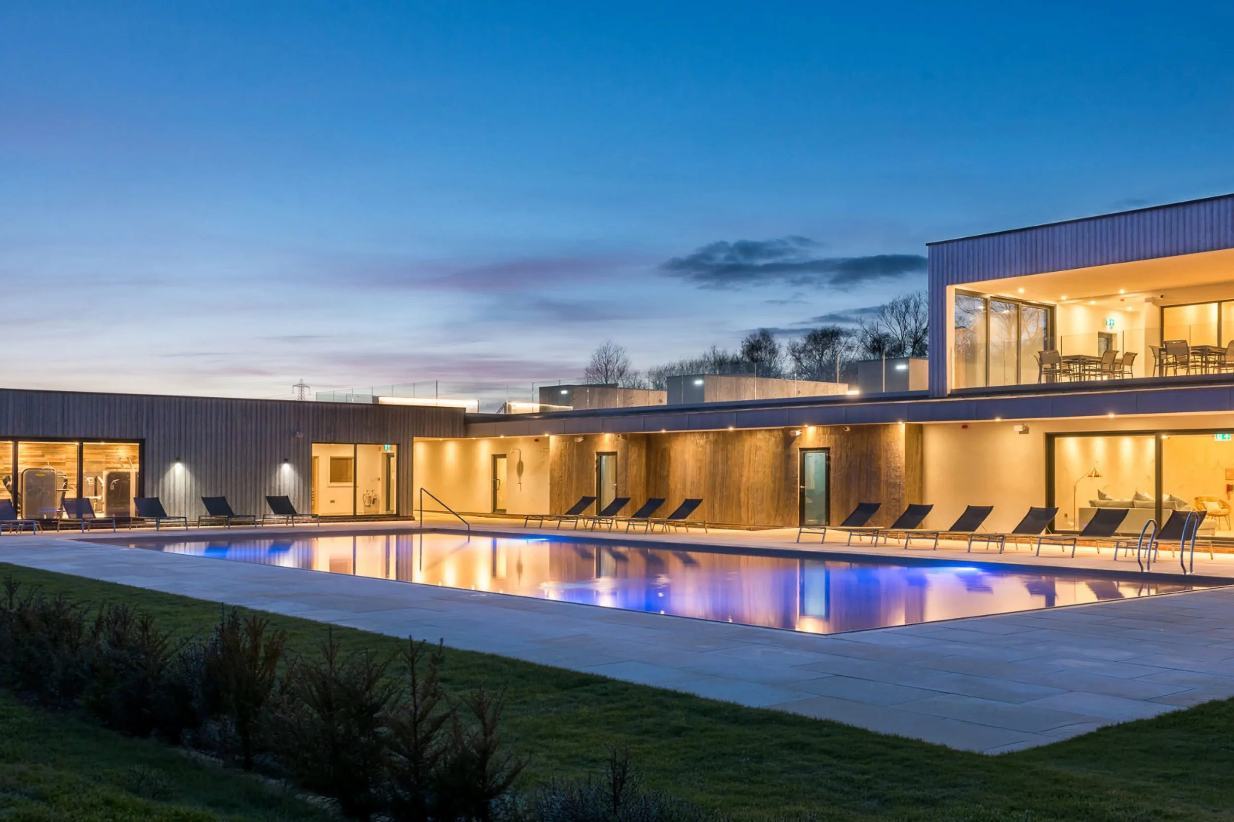 Silverlake Hurricane Spa poolside terrace with timber-clad contemporary architecture overlooking the outdoor pool.