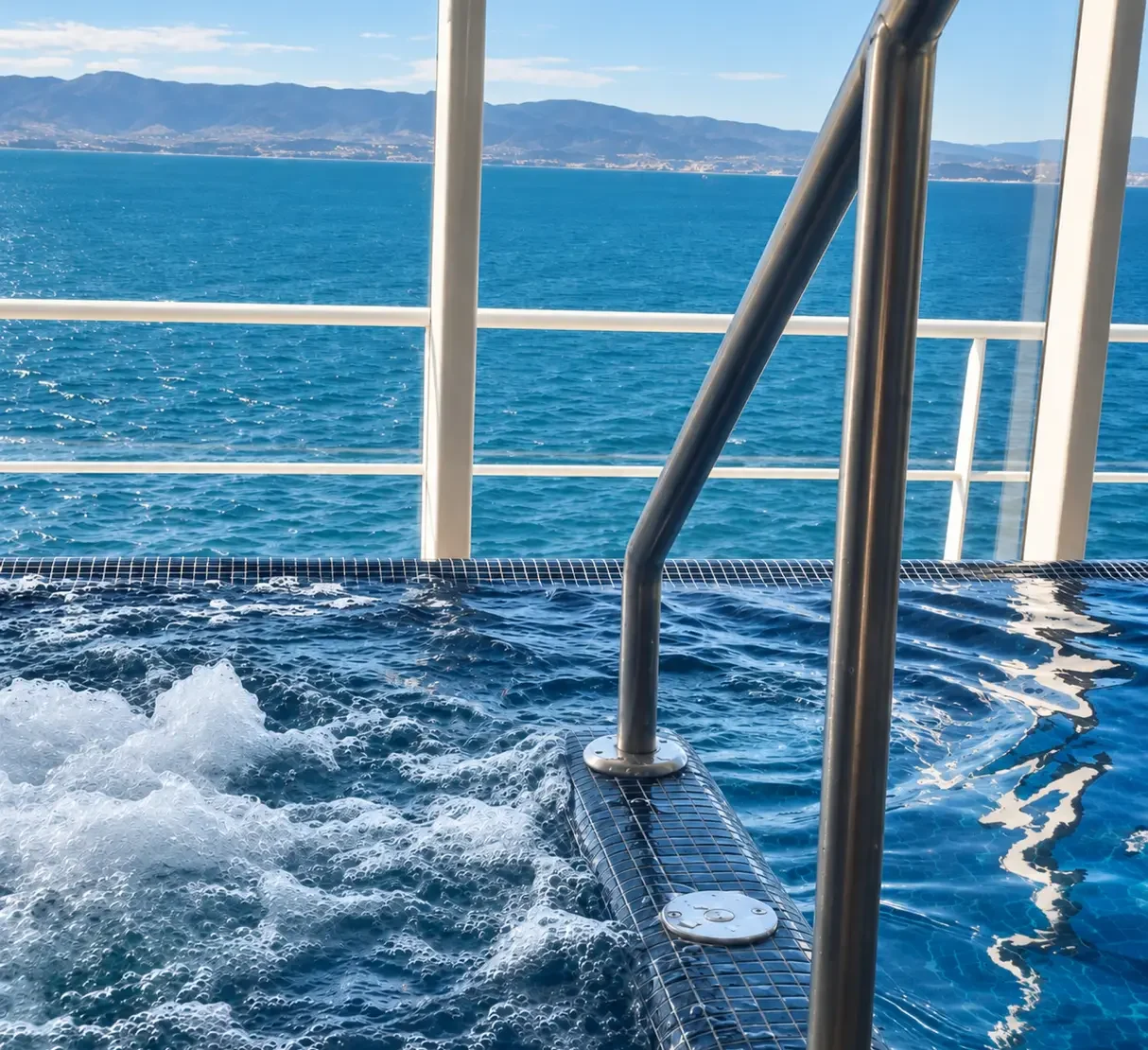 Hydrotherapy pool onboard Marella Explorer with panoramic views across the sea.