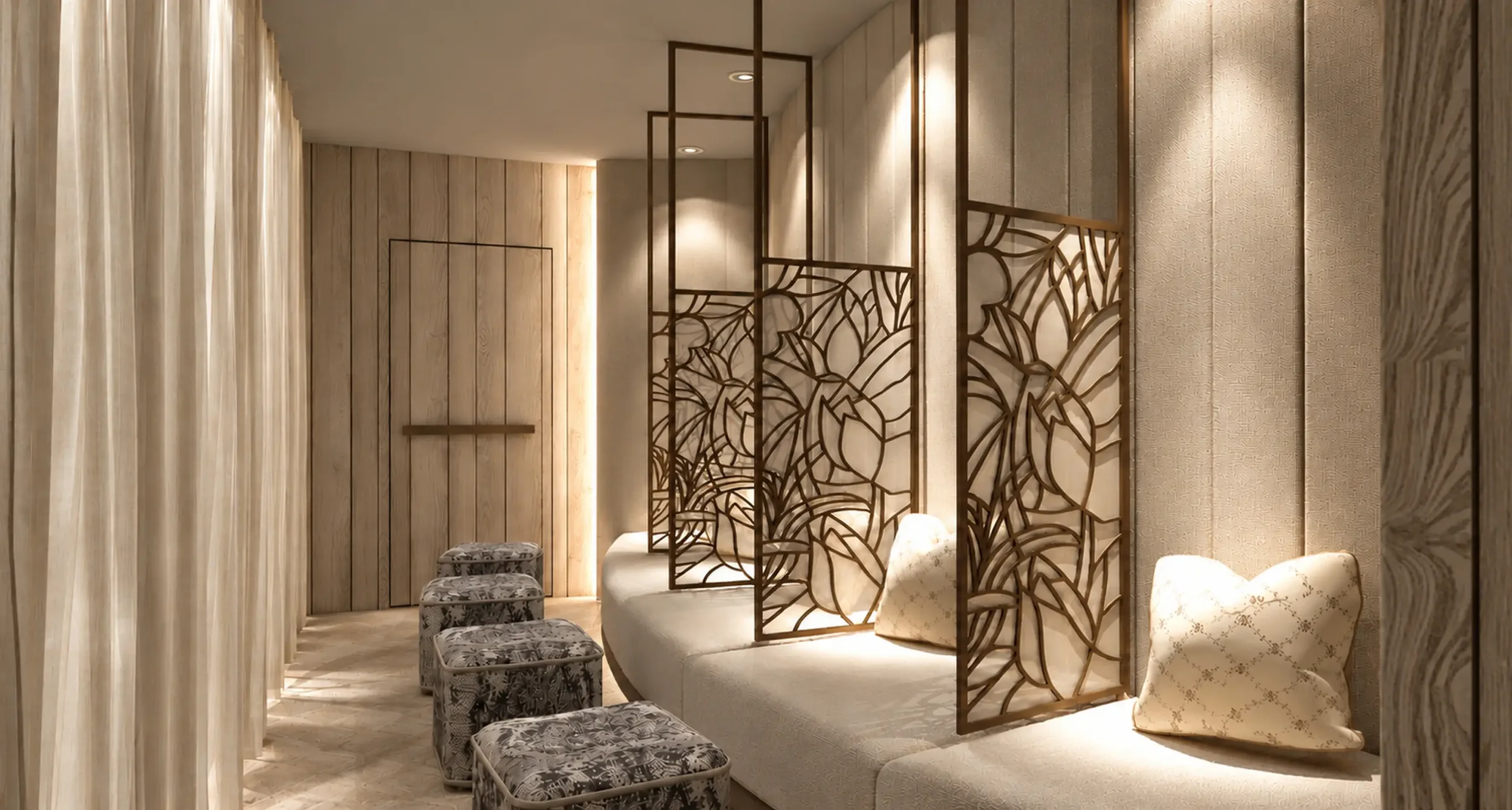 Wide view of the Champneys Springs relaxation suite showing curved seating, decorative metal screens, upholstered stools and softly illuminated timber walls.