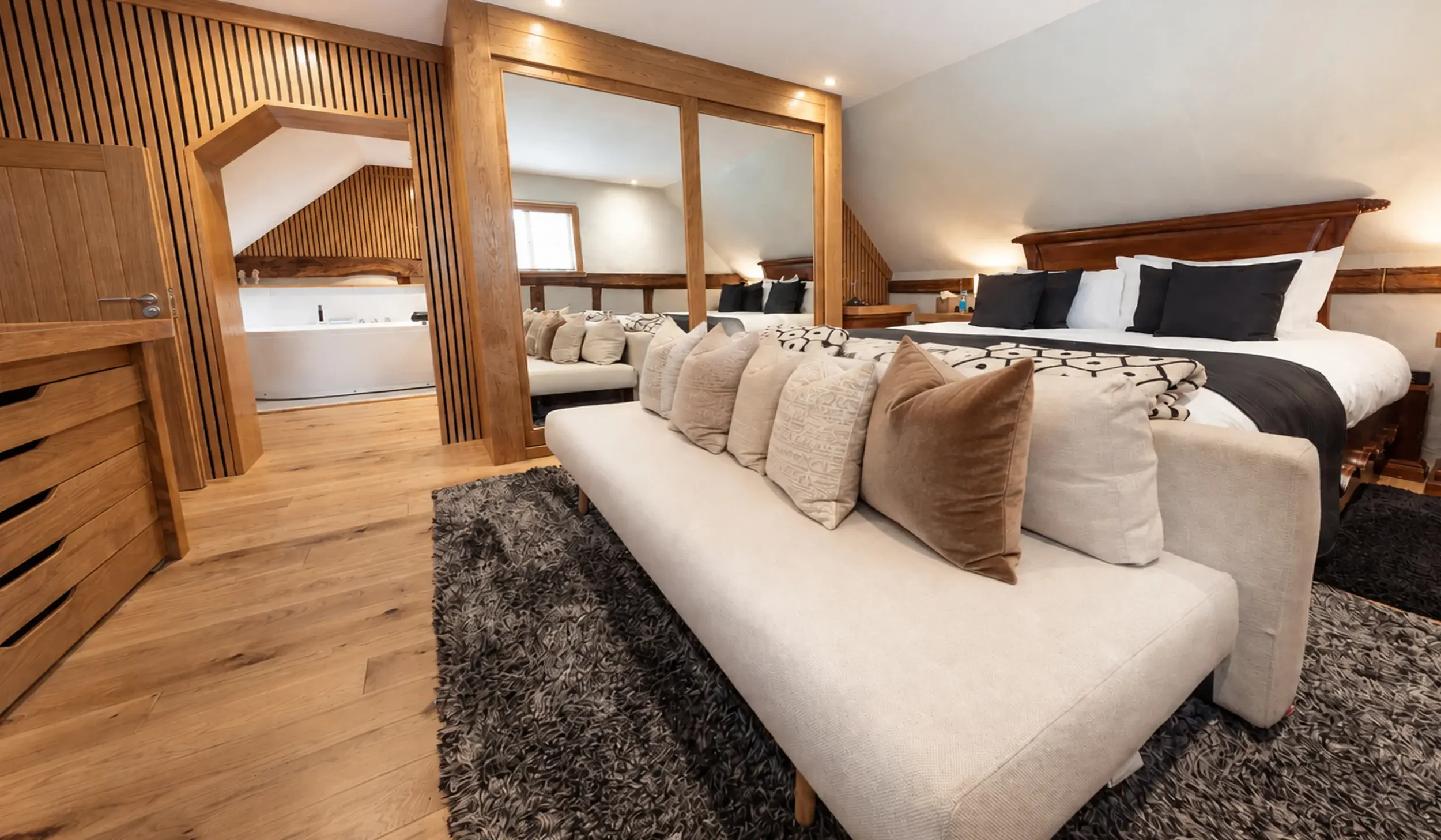 Farmhouse Retreat bedroom suite with bespoke furniture, natural timber finishes and an adjoining bathroom.