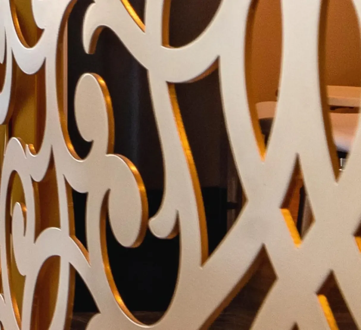 Close-up of the bespoke laser-cut metal pattern developed as a recurring feature throughout the spa.