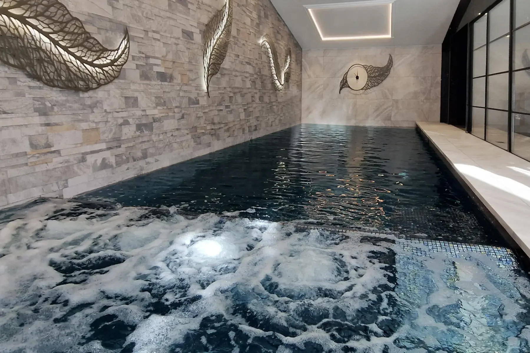 Private residential spa in the New Forest featuring a bespoke indoor hydrotherapy pool.
