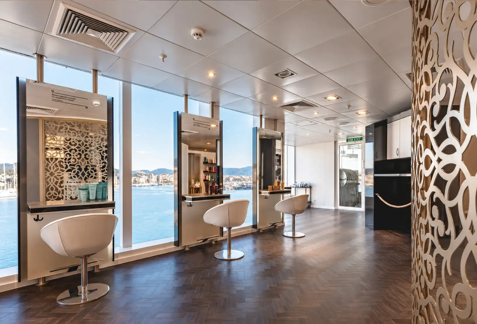 Champneys hair salon with styling stations, mirrors and warm contemporary finishes.