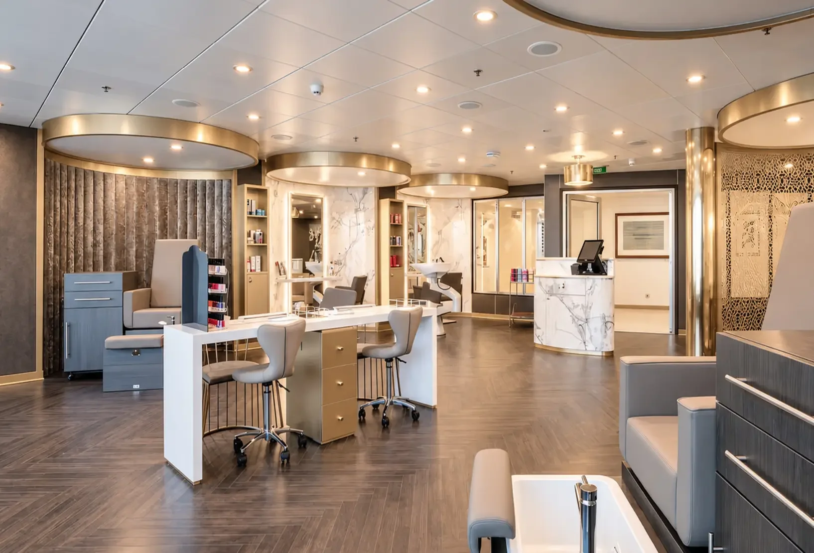 Nail and beauty salon with manicure stations and warm metallic detailing within the onboard spa.