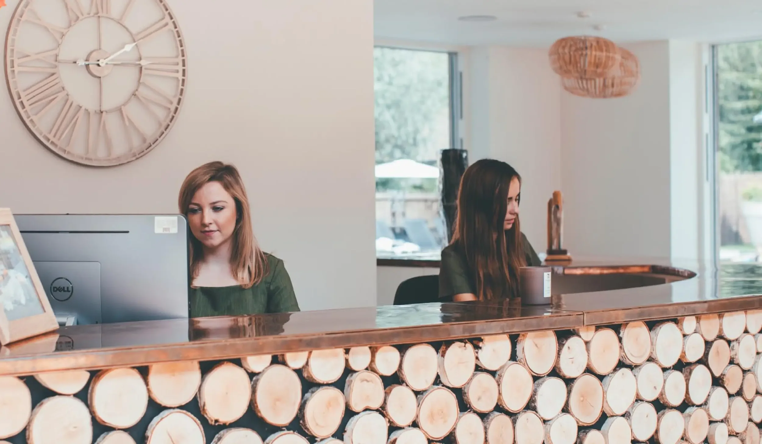 Bespoke reception desk made with natural timber logs and a copper countertop at Lower Mill Estate Spa.