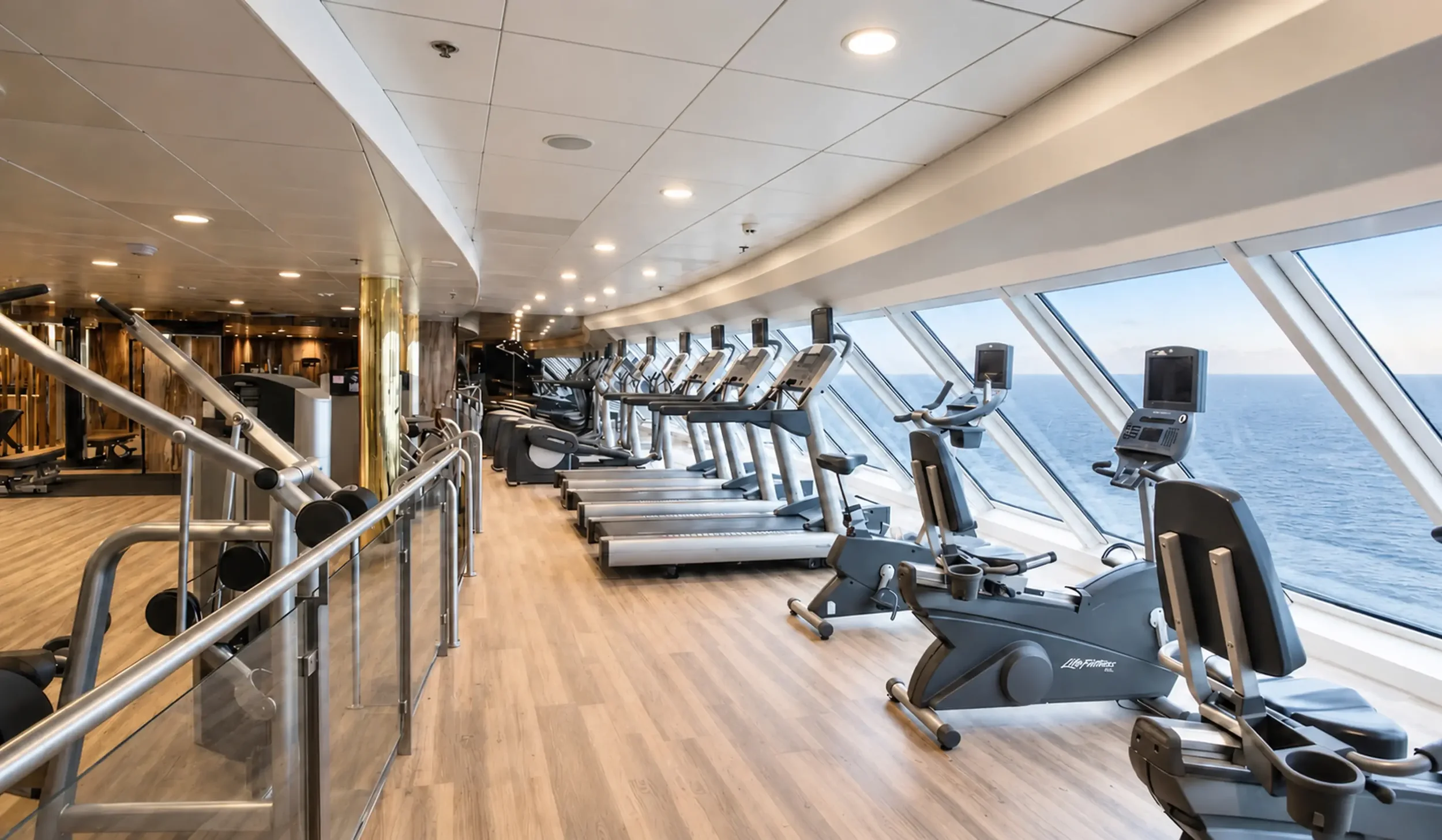 Refurbished onboard gym with updated flooring and bespoke entrance detailing.