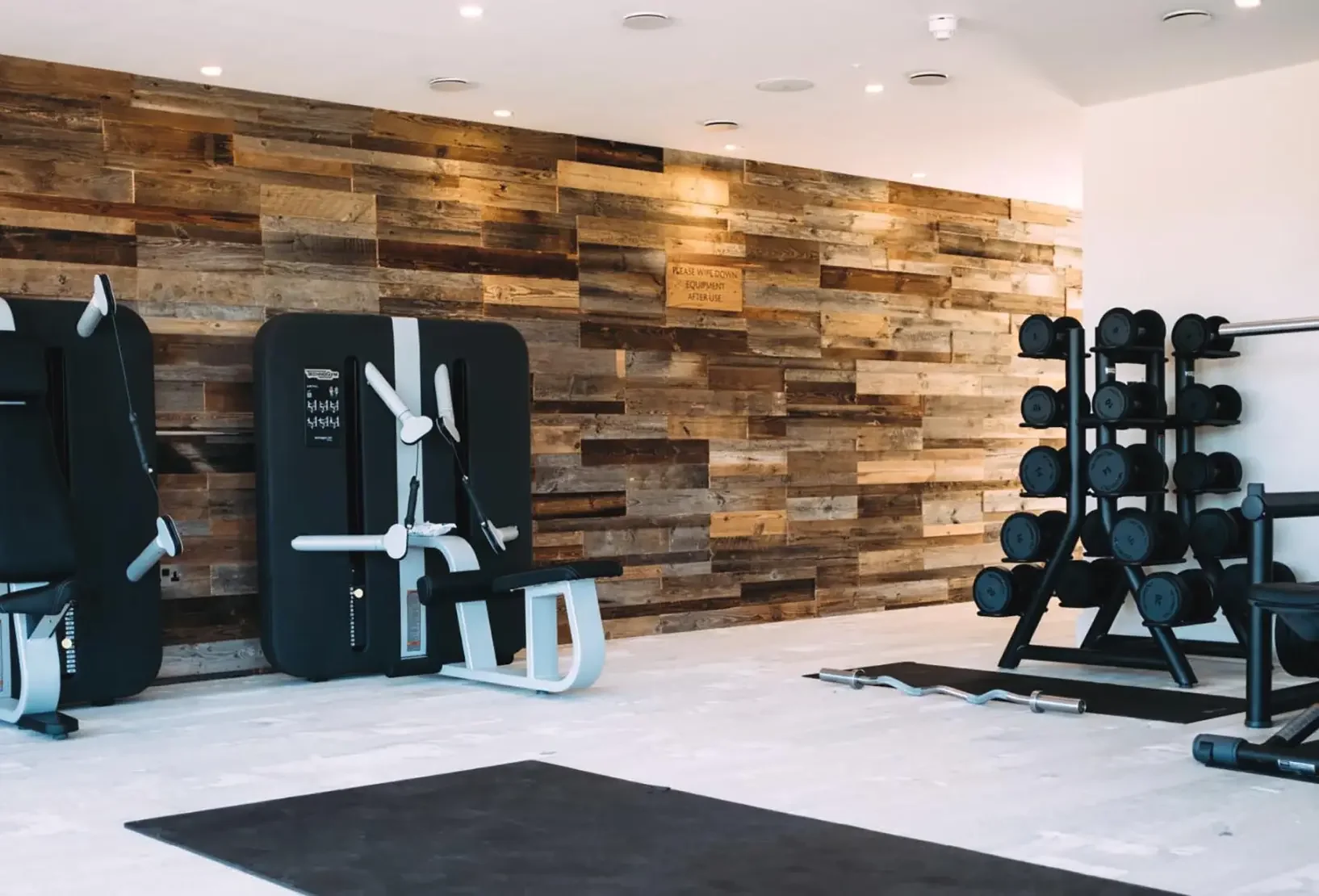 Silverlake Spa gym with fitness equipment and a reclaimed timber feature wall.