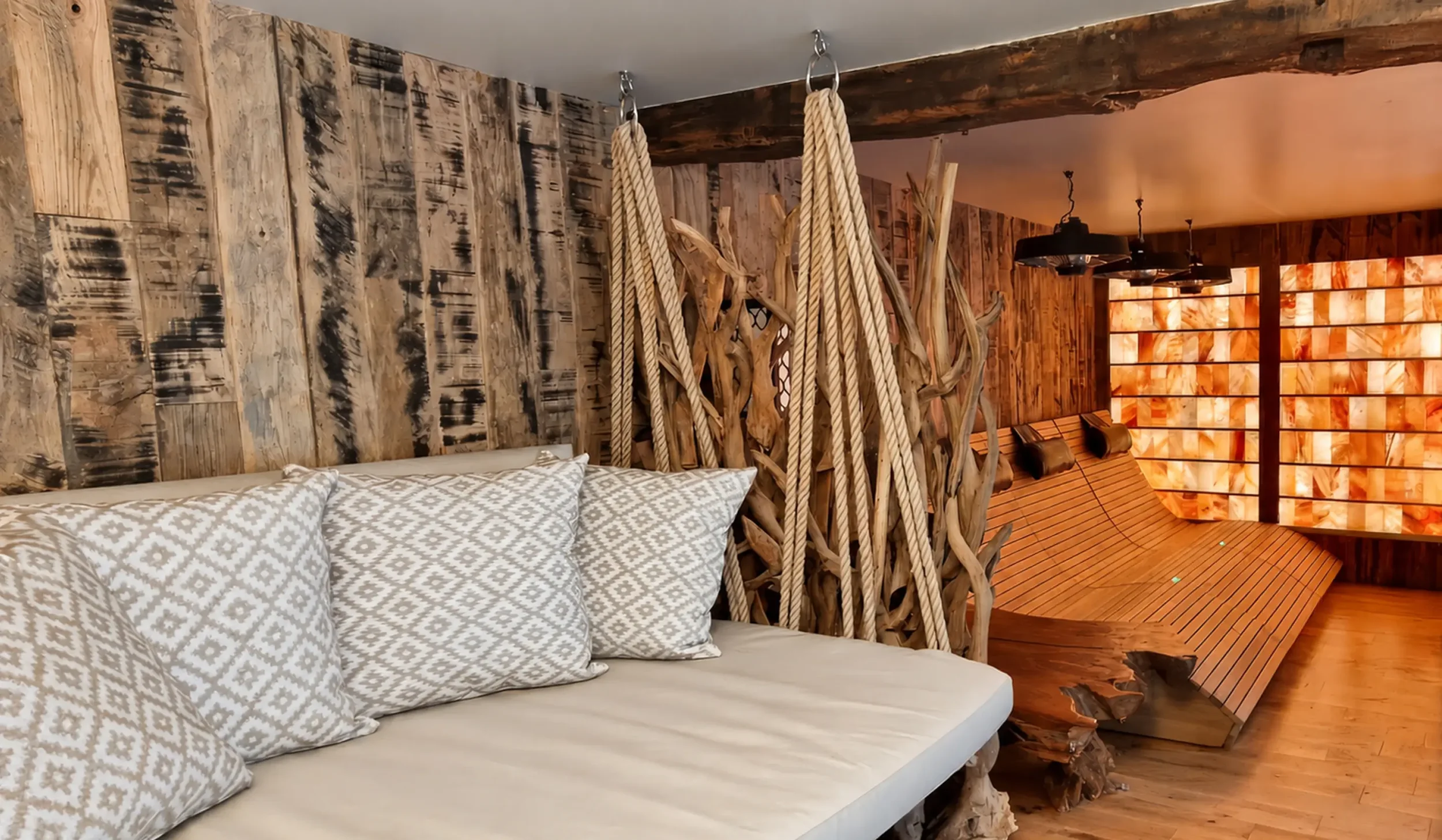 Bespoke hanging daybeds with timber detailing, creating a relaxed and sociable space between wellness experiences.