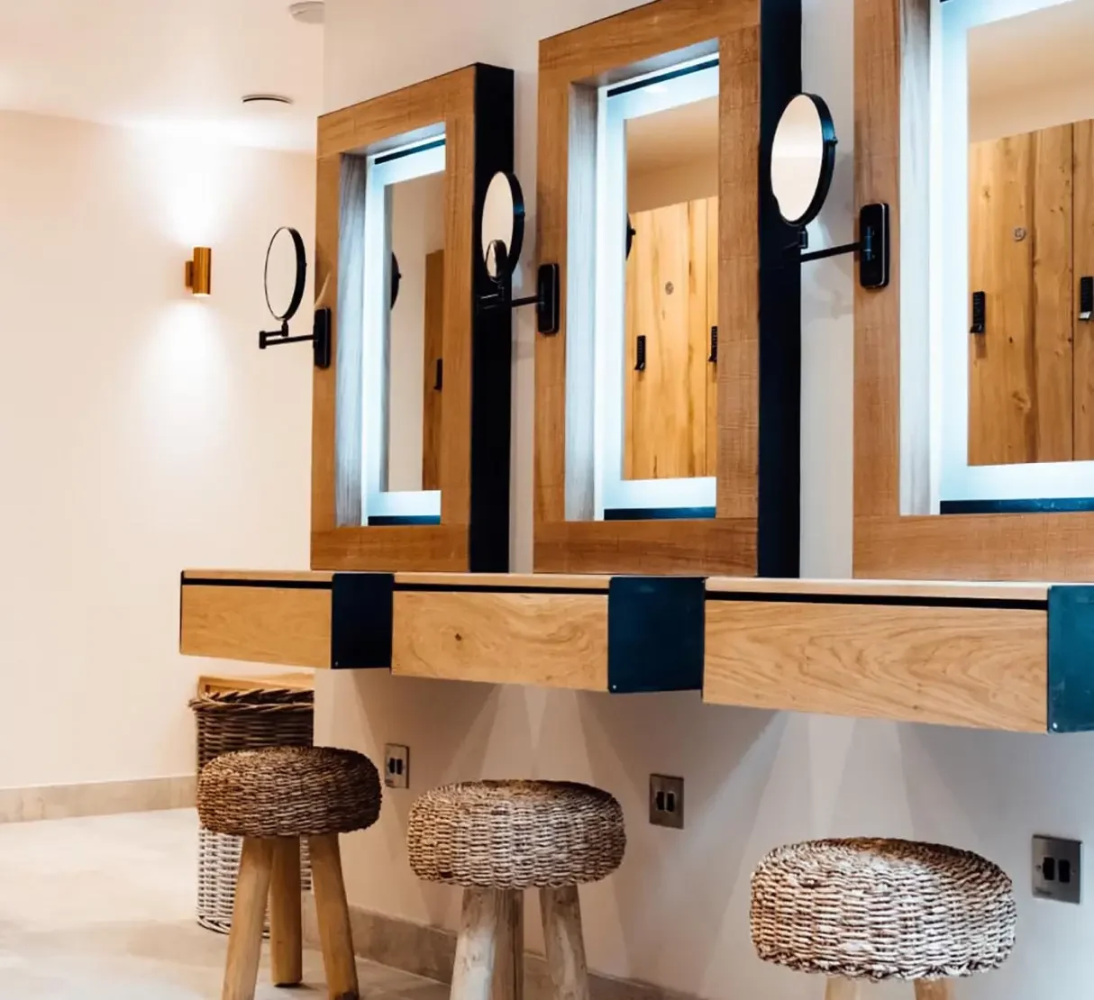 Spa changing area with bespoke timber vanity units, mirrors and integrated lighting at Silverlake.