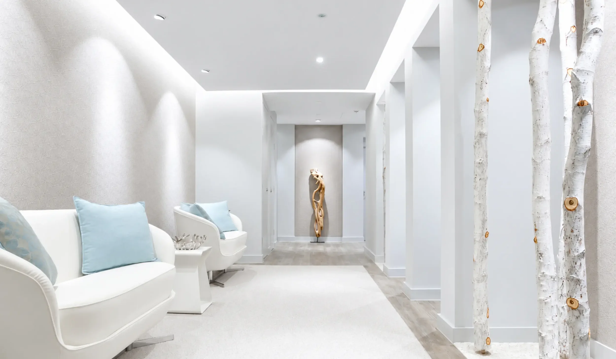 White clinical treatment corridor with natural birch tree detailing