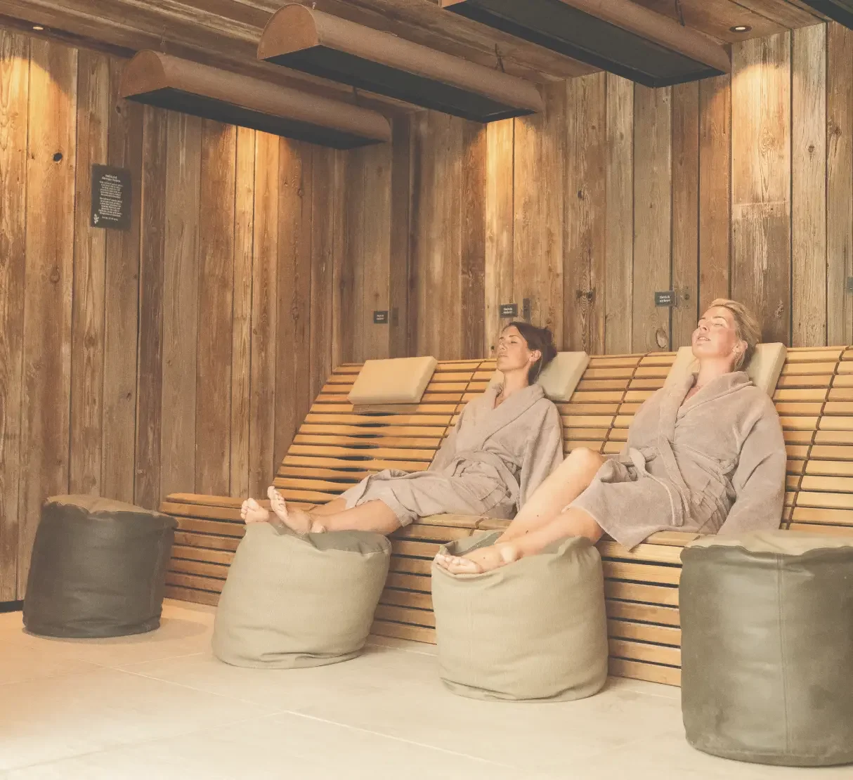 Homefield Grange spa interior with rustic timber walls and farmhouse trough-inspired infrared features, reflecting the retreat’s original dairy farm heritage.