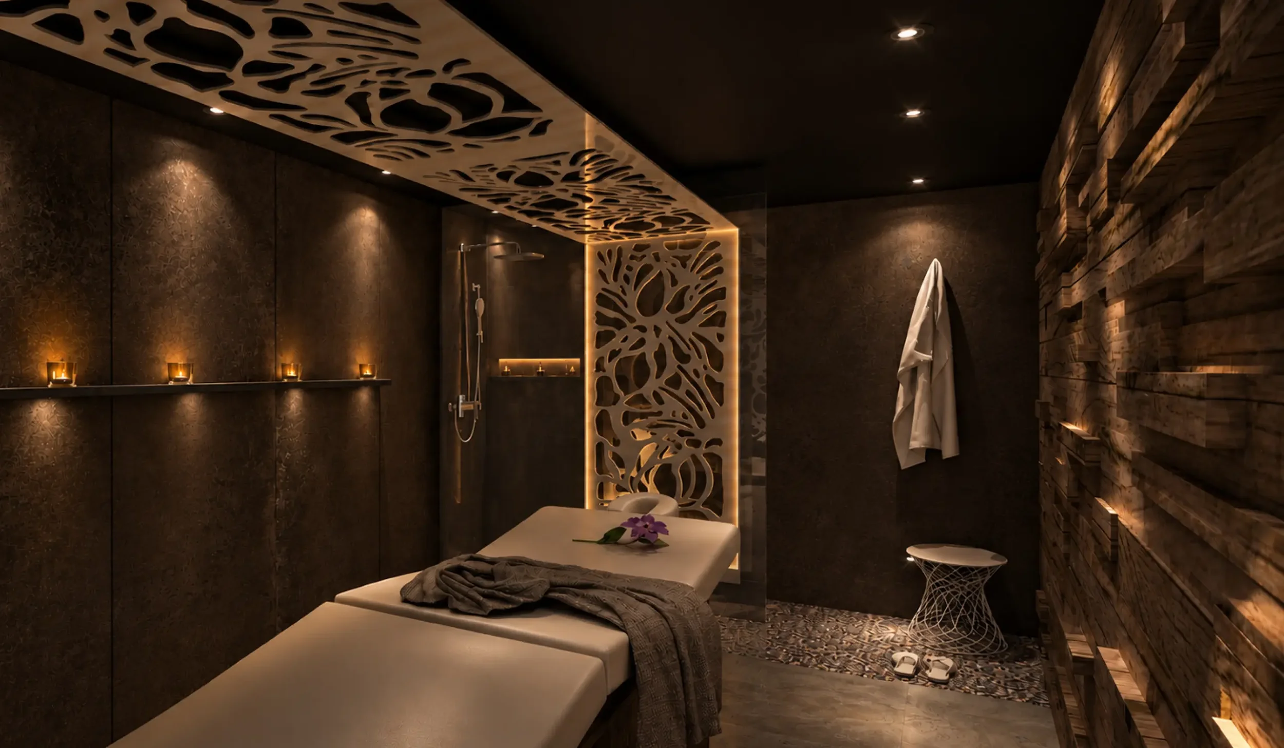 Luxury spa treatment room concept at Champneys Springs with a massage bed, dark textured walls, bespoke decorative screens and atmospheric lighting.