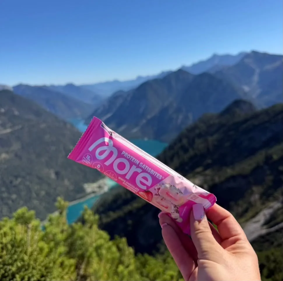 Proteinriegel als kleine Stärkung bei der Gipfelpause am Zunterkopf mit Blick auf den Plansee.