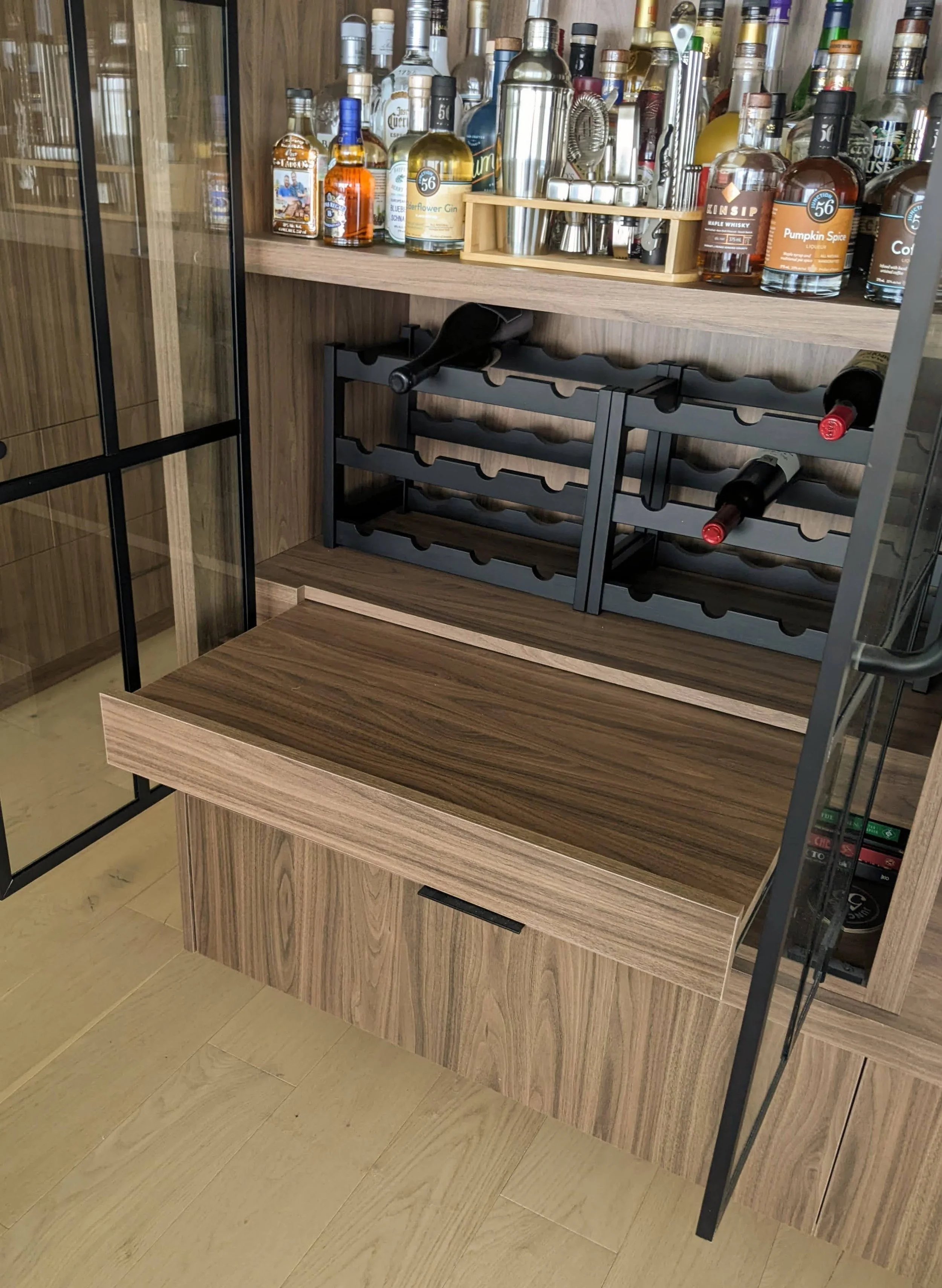 The bar features a pull out shelf for mixing cocktails.