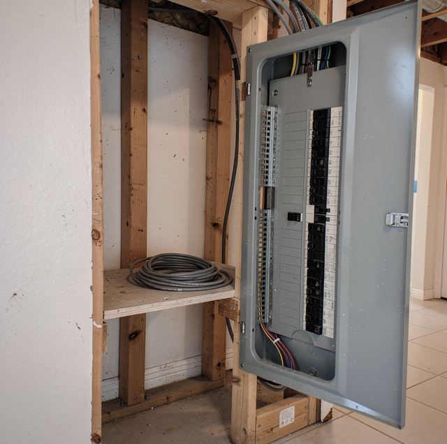 open residential breaker panel with labeled circuit switches