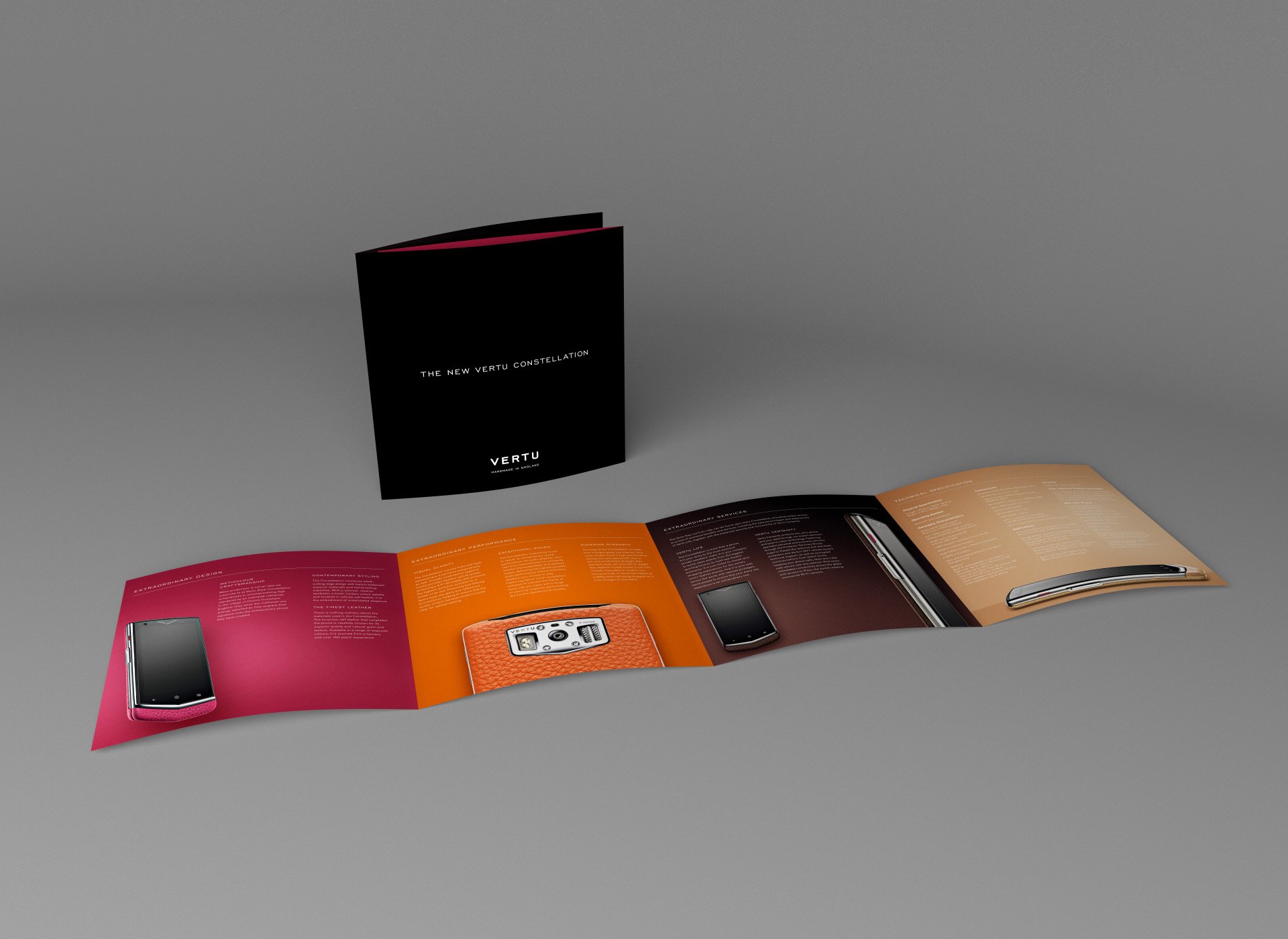 Open magazine displaying colorful pages with electronic device images, alongside a pink smartphone with a black screen.