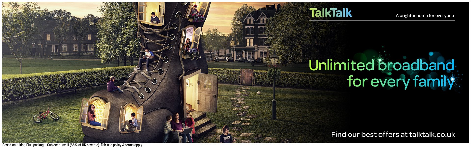 An advertisement for TalkTalk internet service featuring a giant shoe-shaped house with open windows and people sitting and standing on different parts of the shoe, set in a park with trees and houses in the background.
