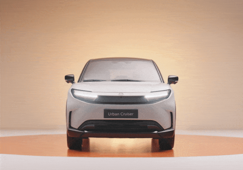 Front view of a silver SUV labeled 'Urban Cruiser' on a beige background.